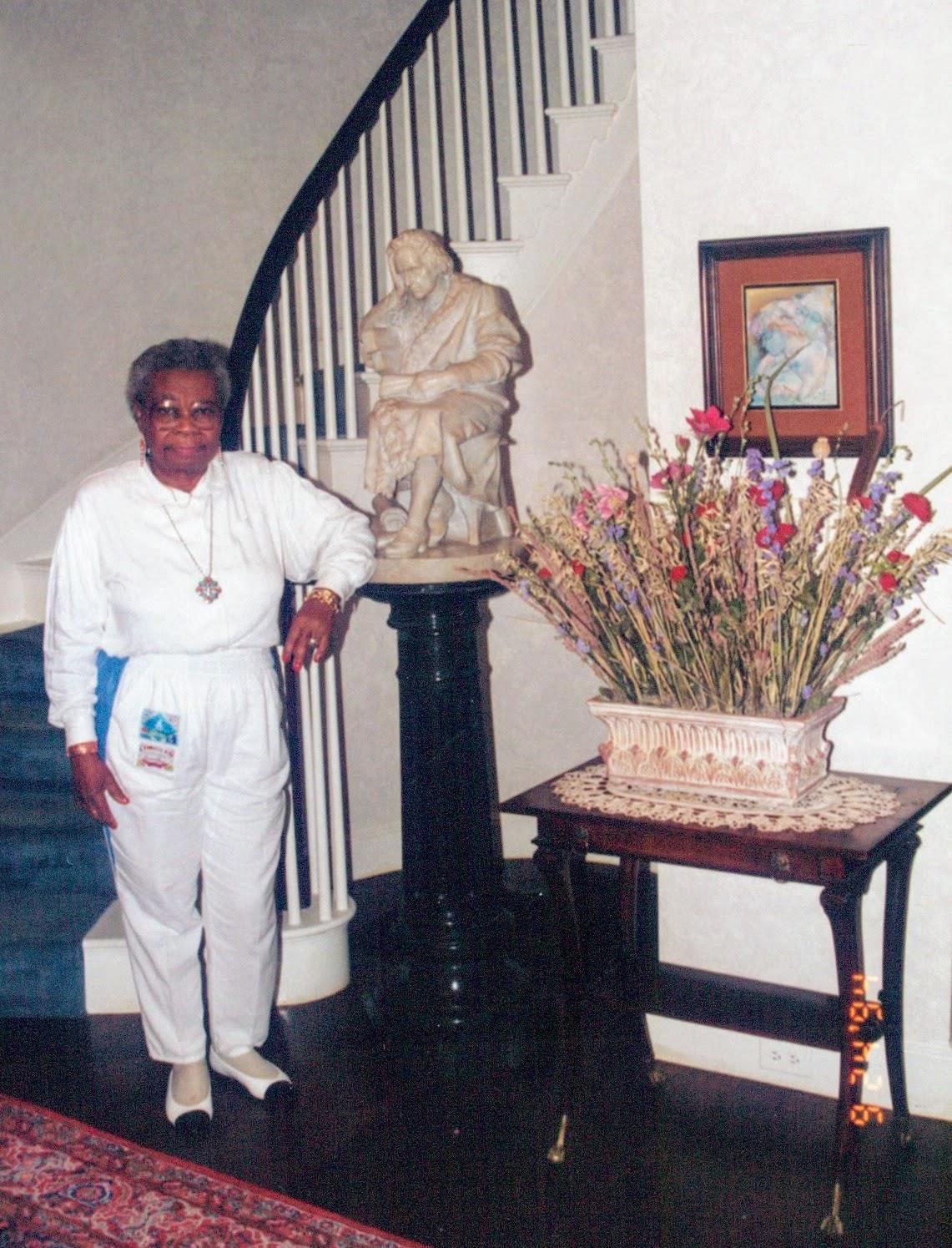 A woman standing next to a statue
