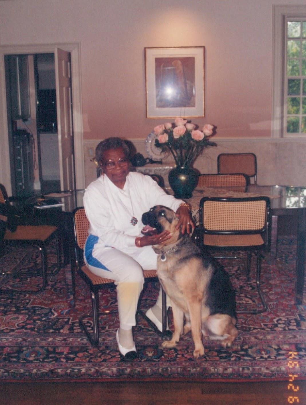 A woman sitting in a chair with a dog