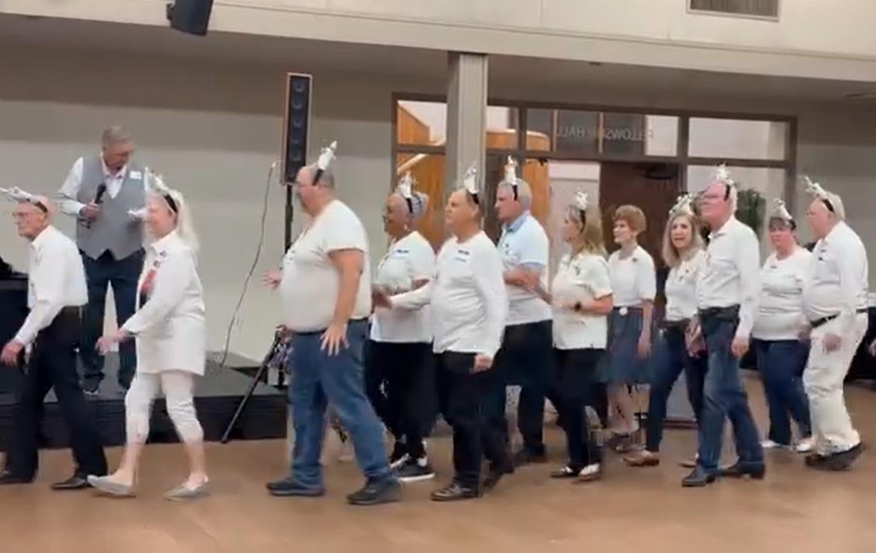 A group of people wearing white shirts