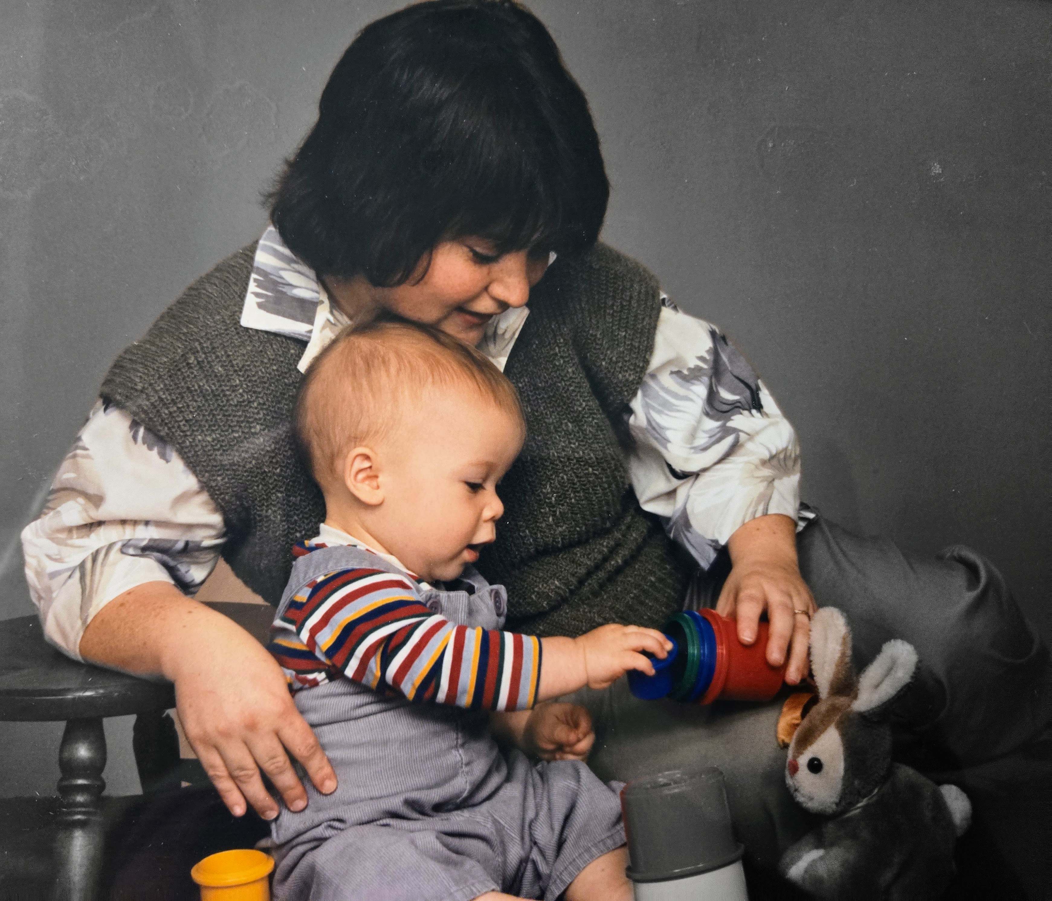 A woman and baby playing with toys