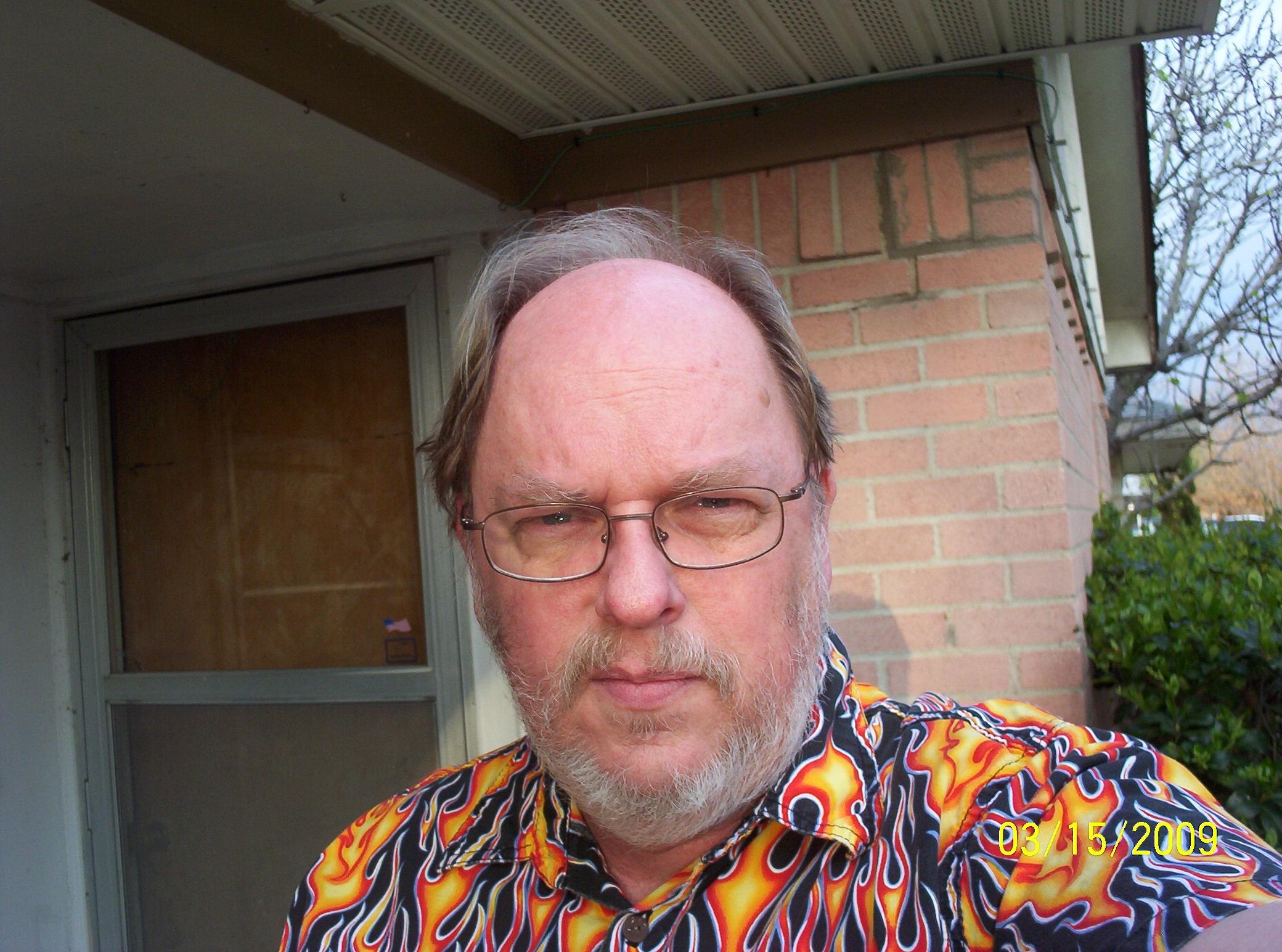 A man with glasses and a beard