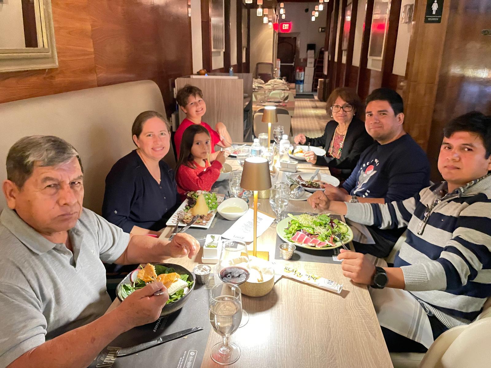 A group of people sitting at a table eating