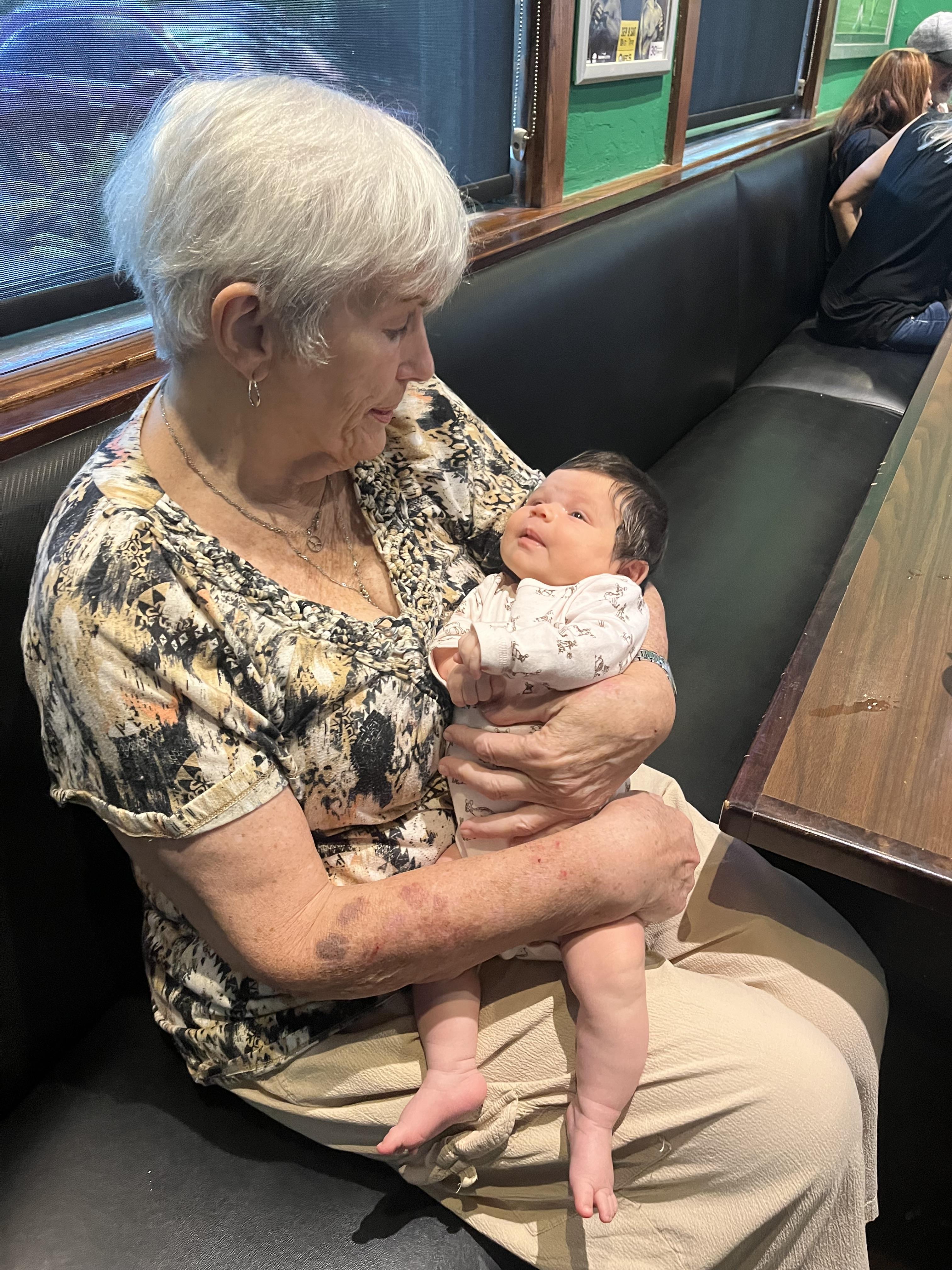 An old woman holding a baby
