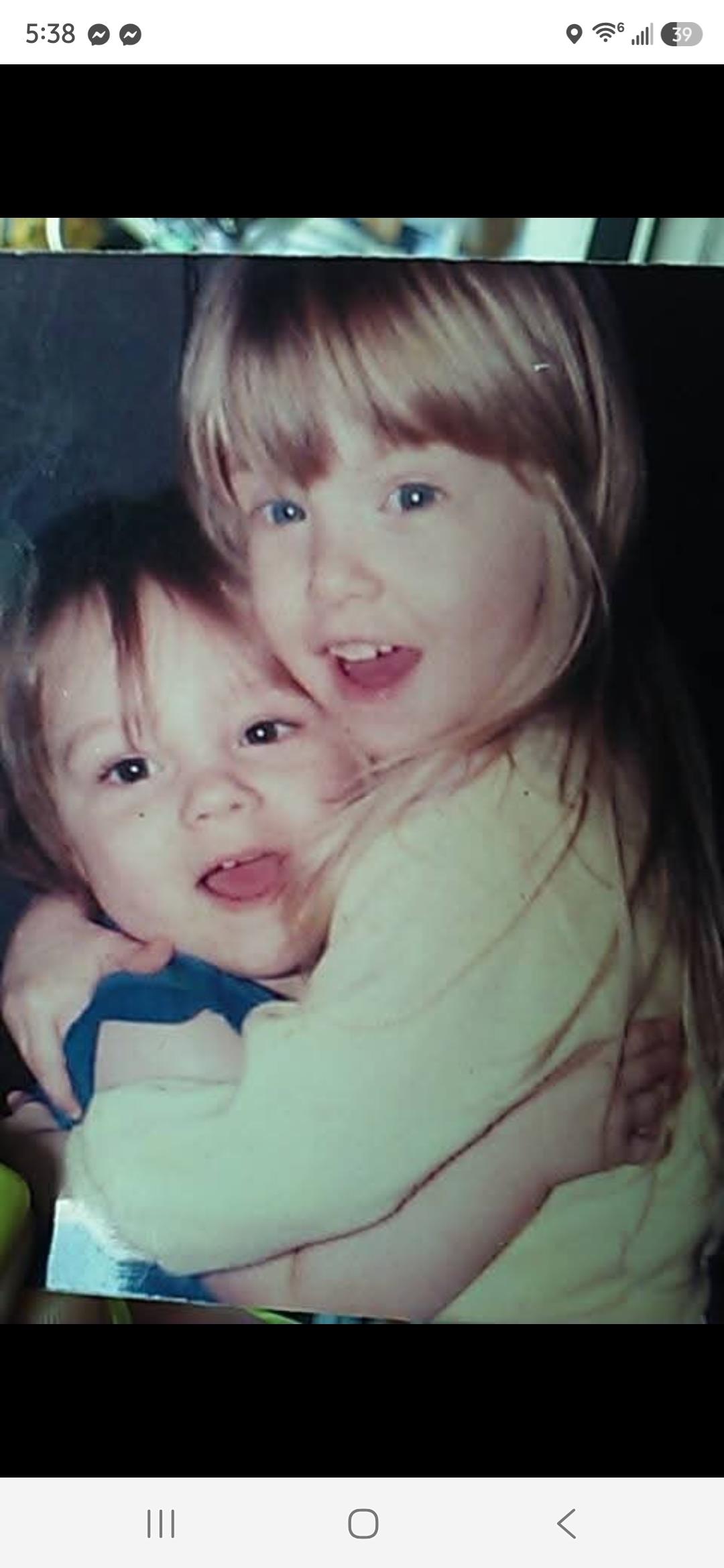 A couple of children hugging