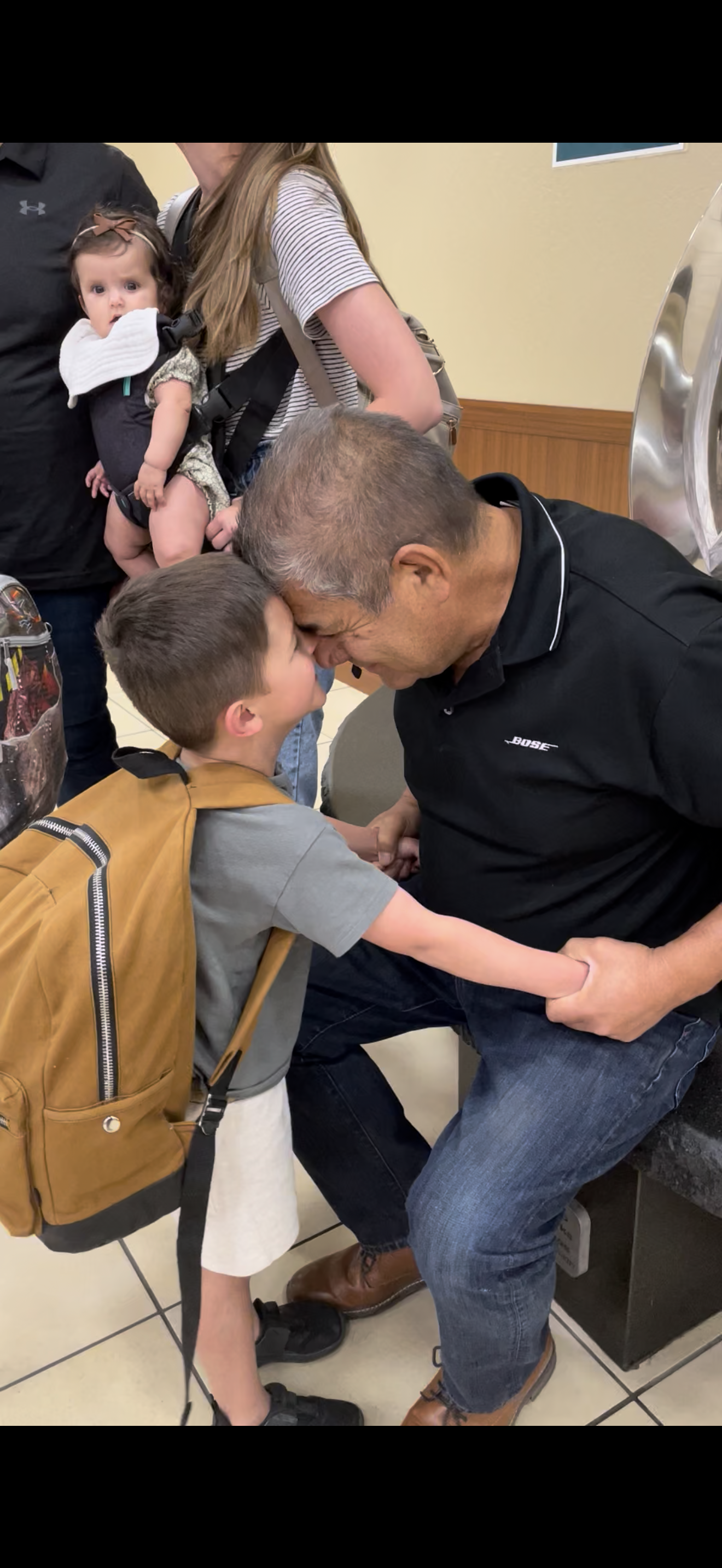 A man and boy kissing each other