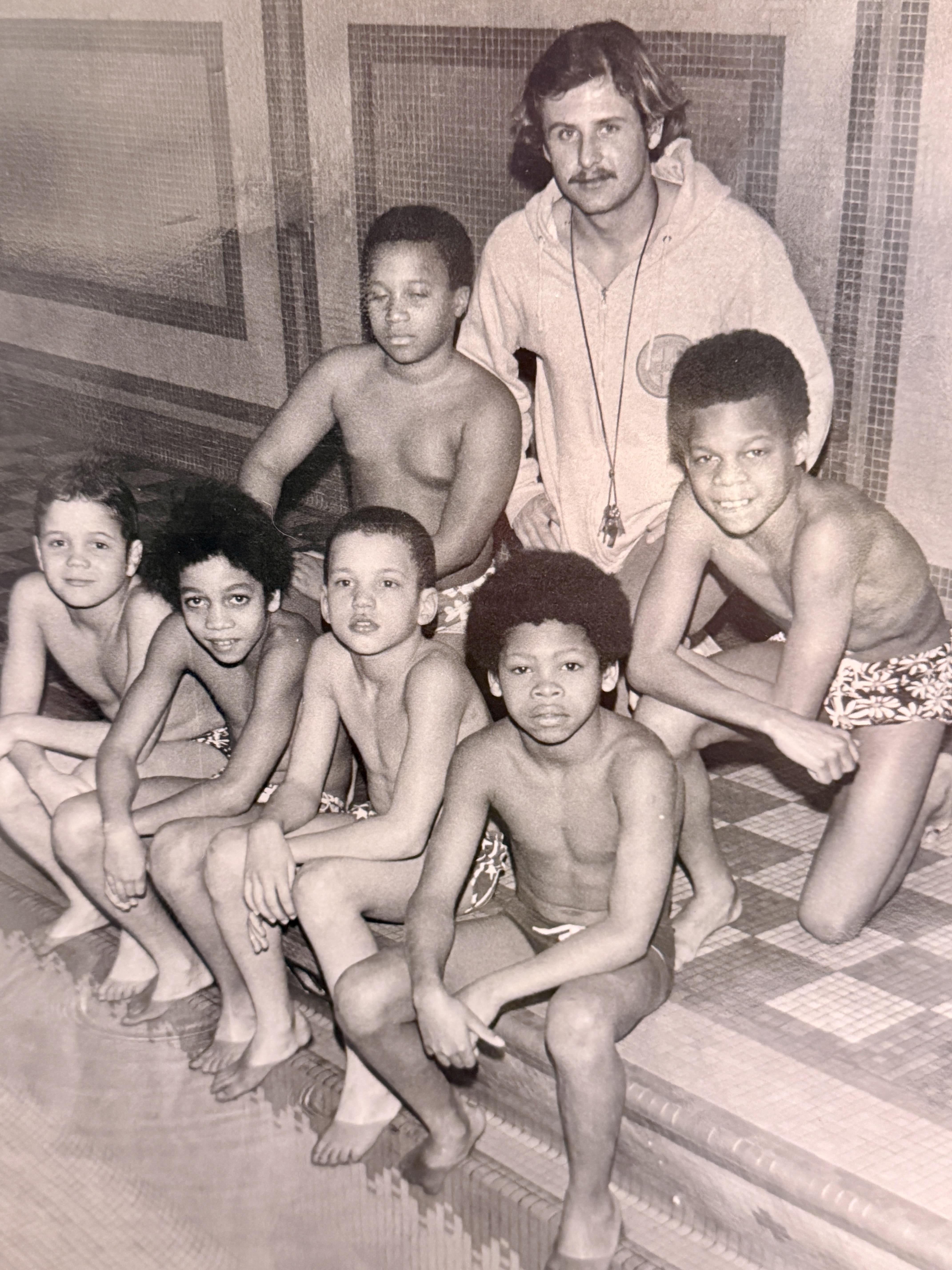A group of boys sitting on a tile floor