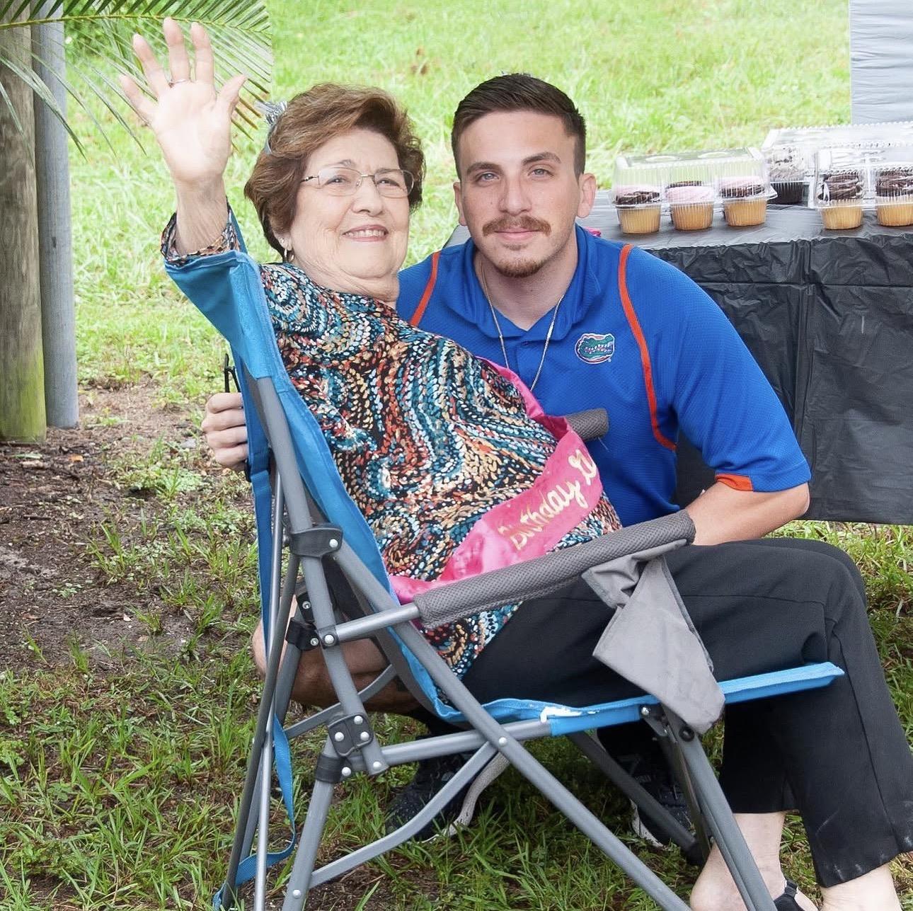 A man and woman sitting in a folding chair