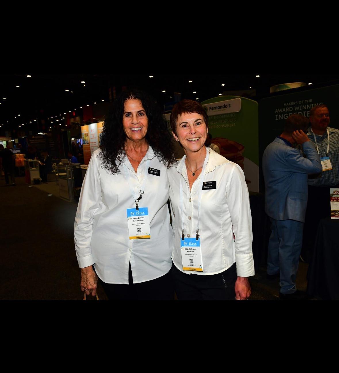A couple of women wearing name badges