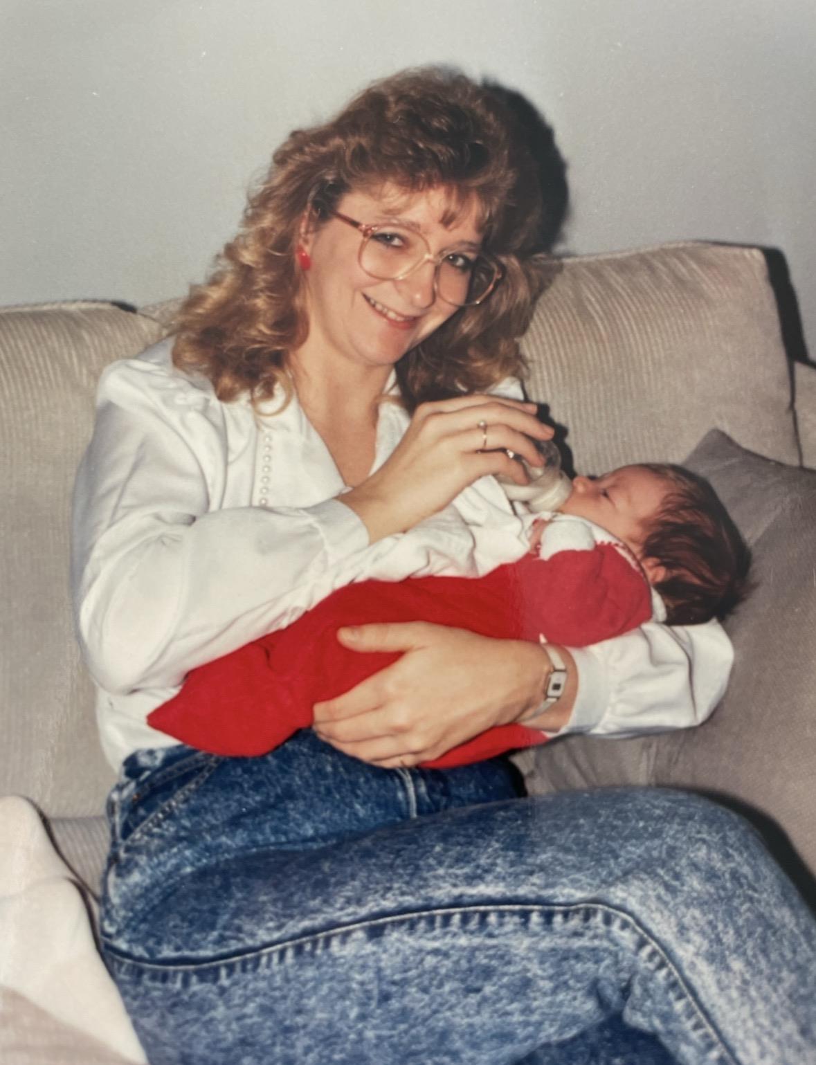 A woman feeding a baby
