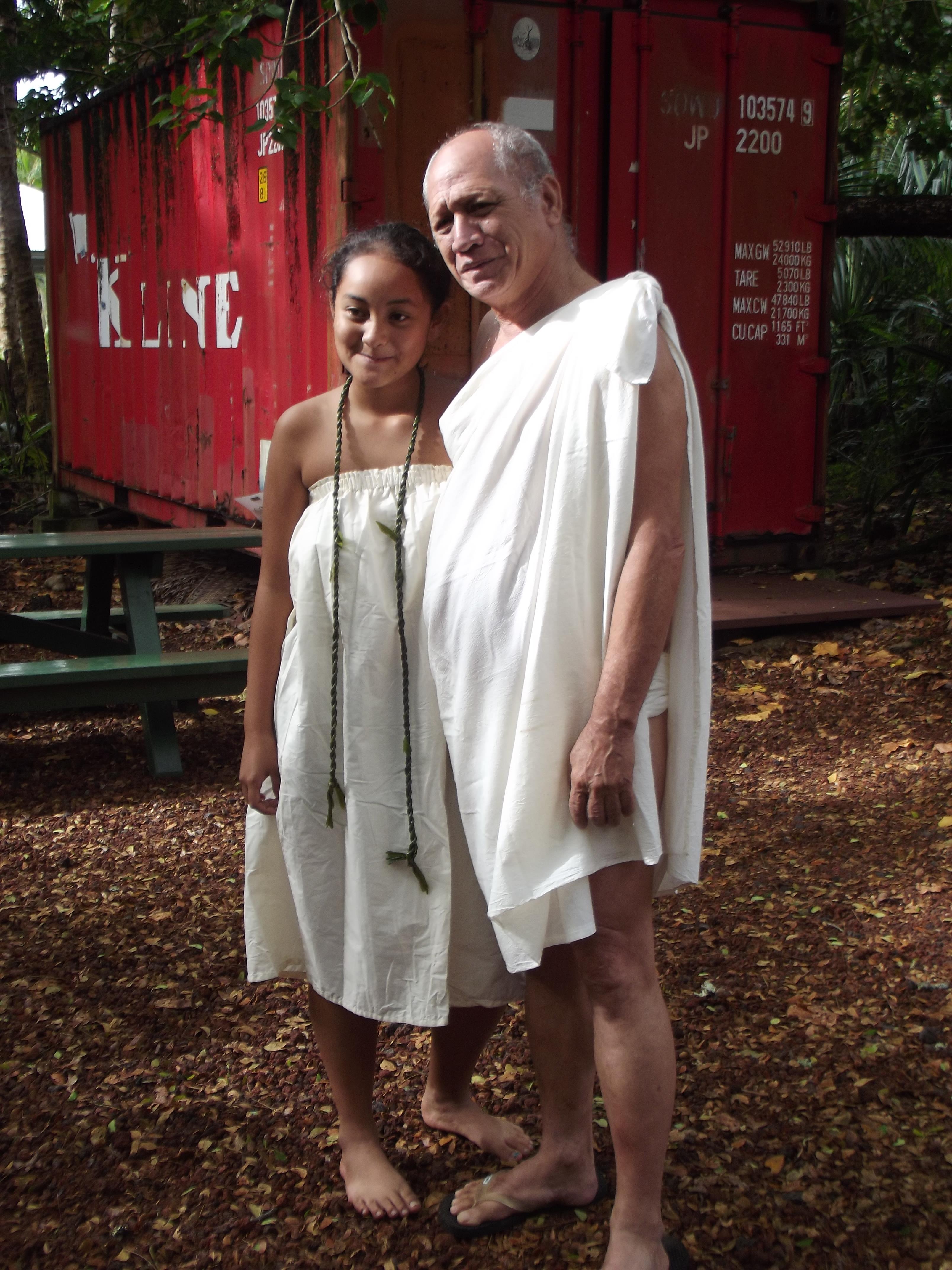 A man and woman in white dresses