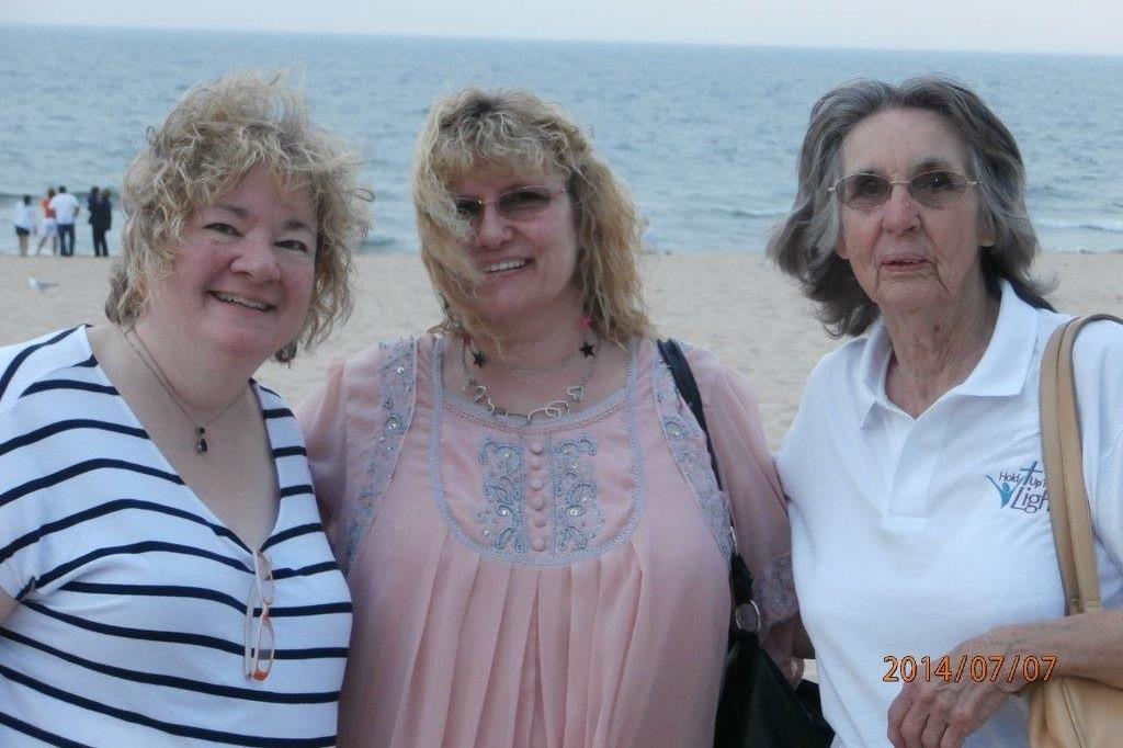 A group of women standing on a beach