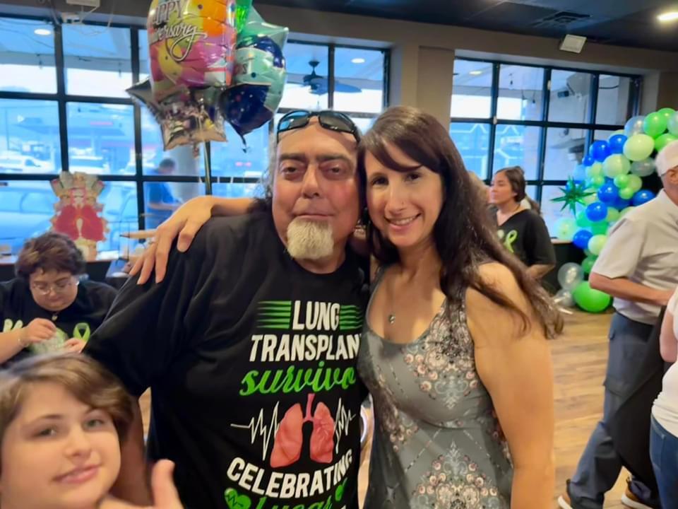 A man and woman posing for a picture
