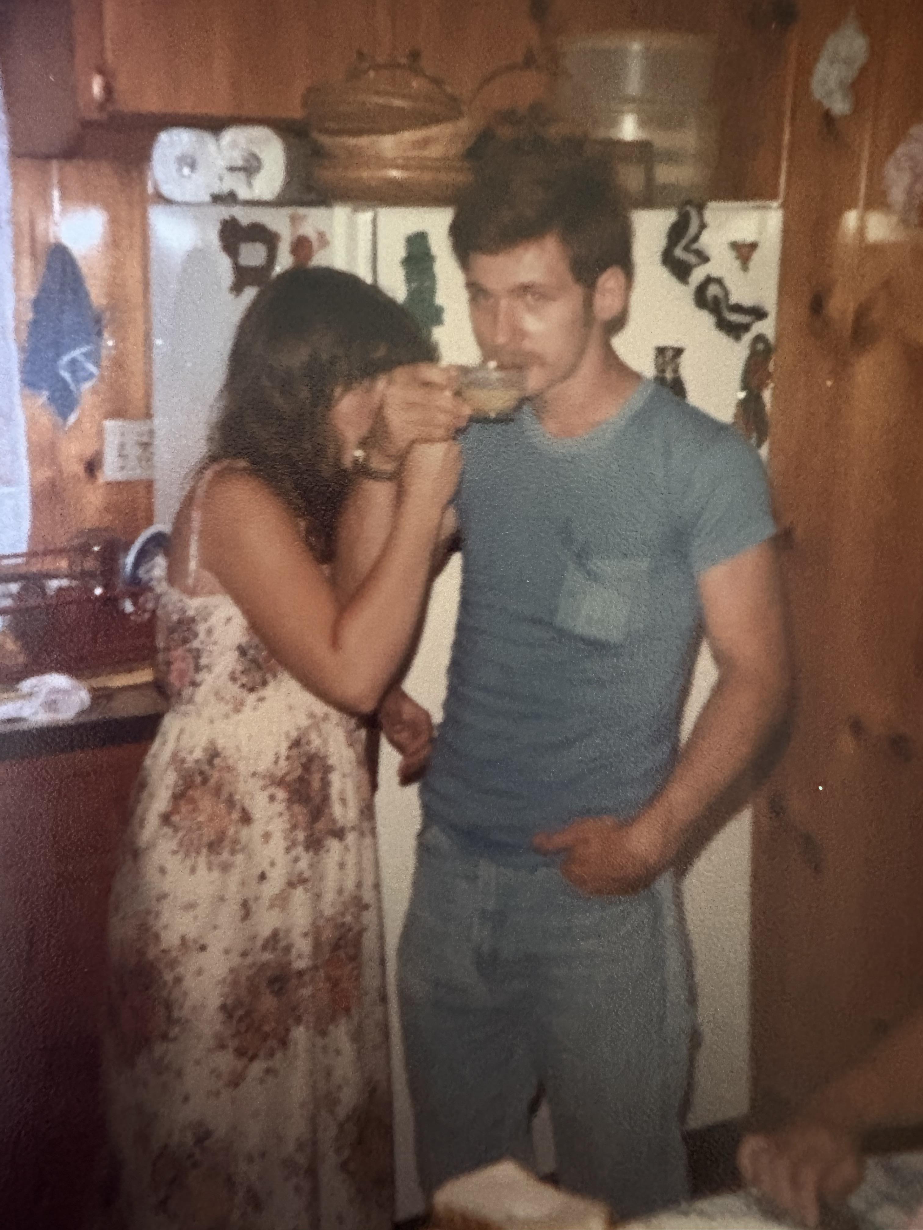 A man and woman standing in a kitchen