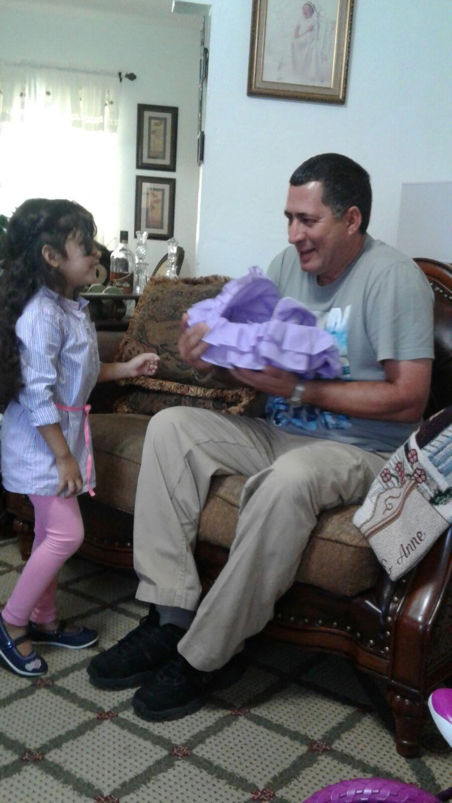 A man holding a baby in a chair