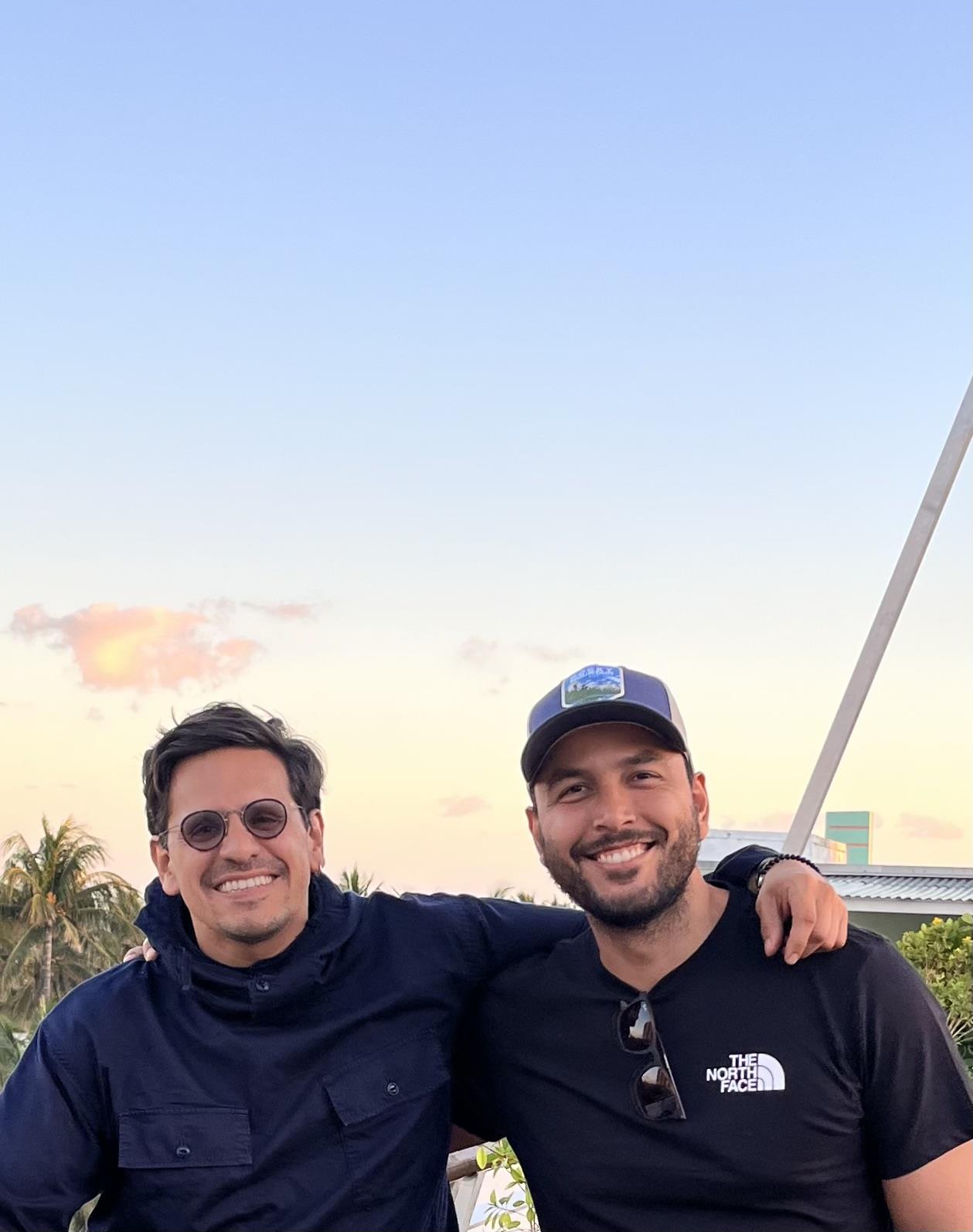 Two men standing together smiling