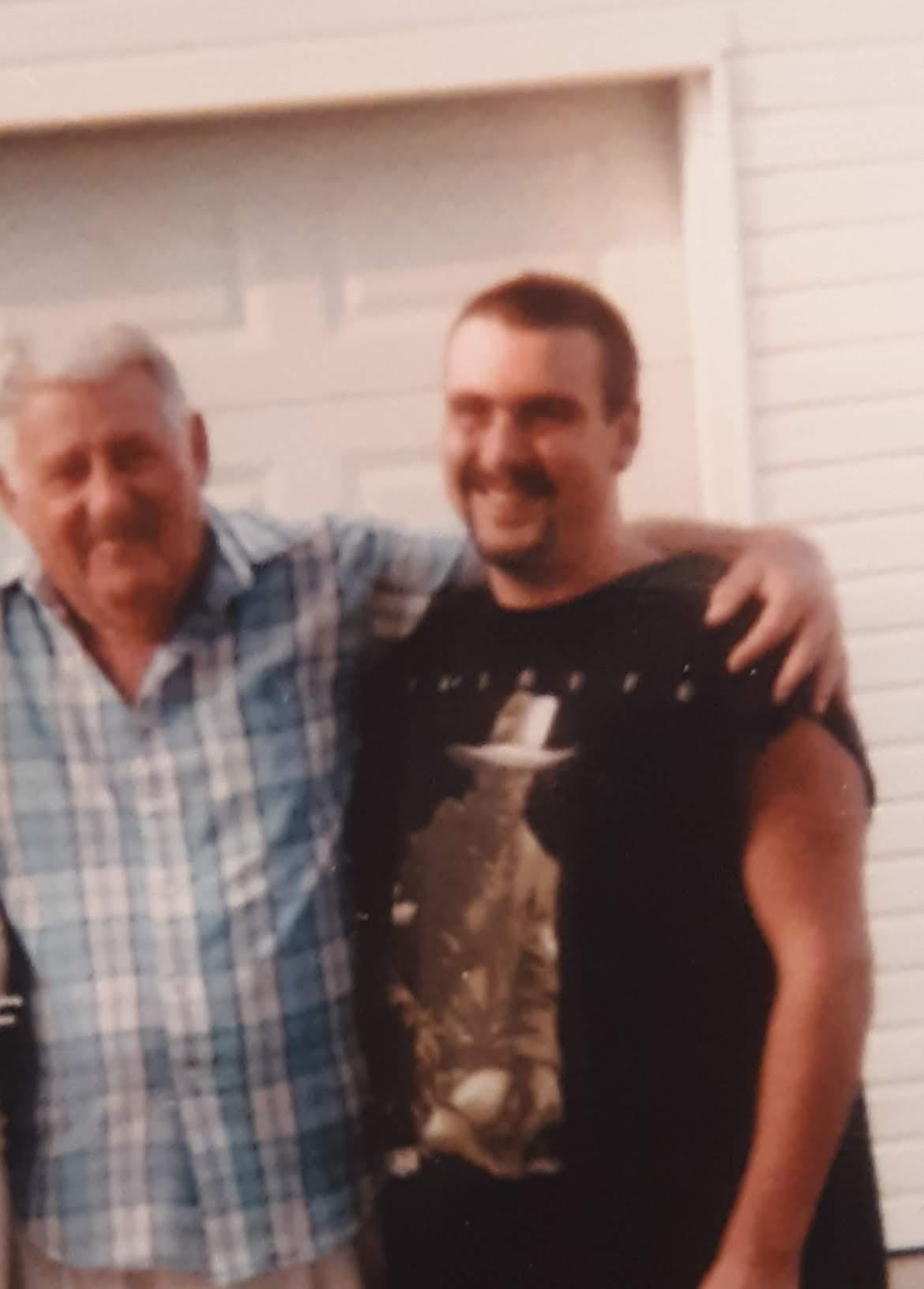 A man with his arm around another man
