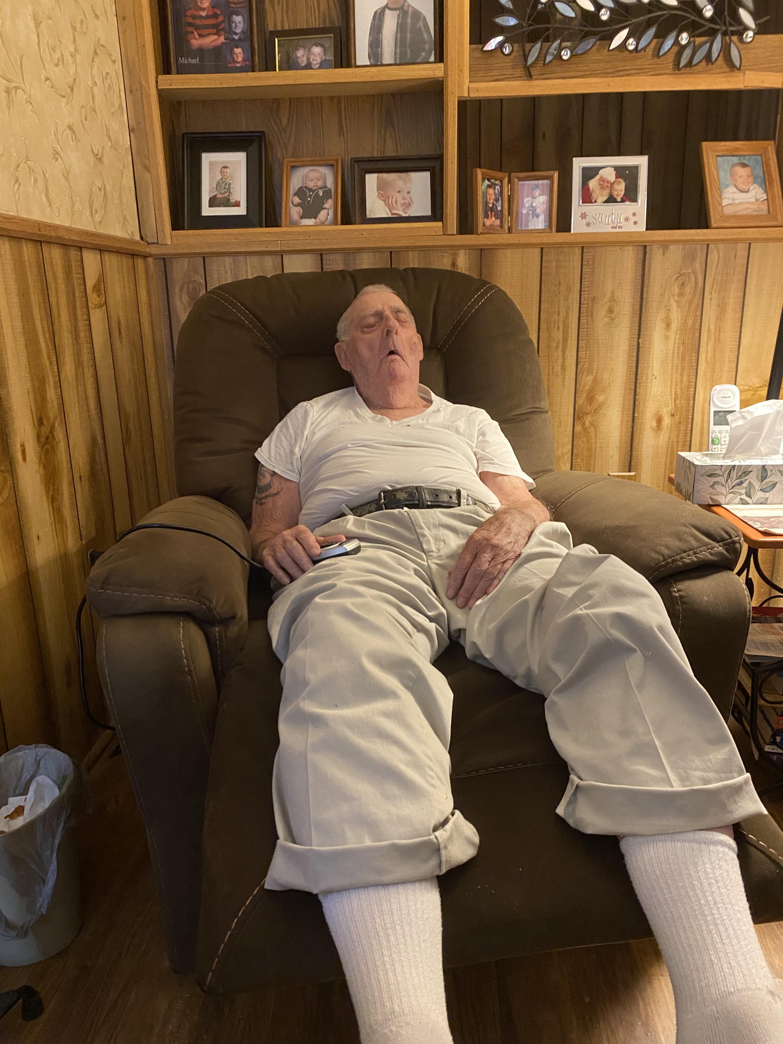 A man lying in a chair