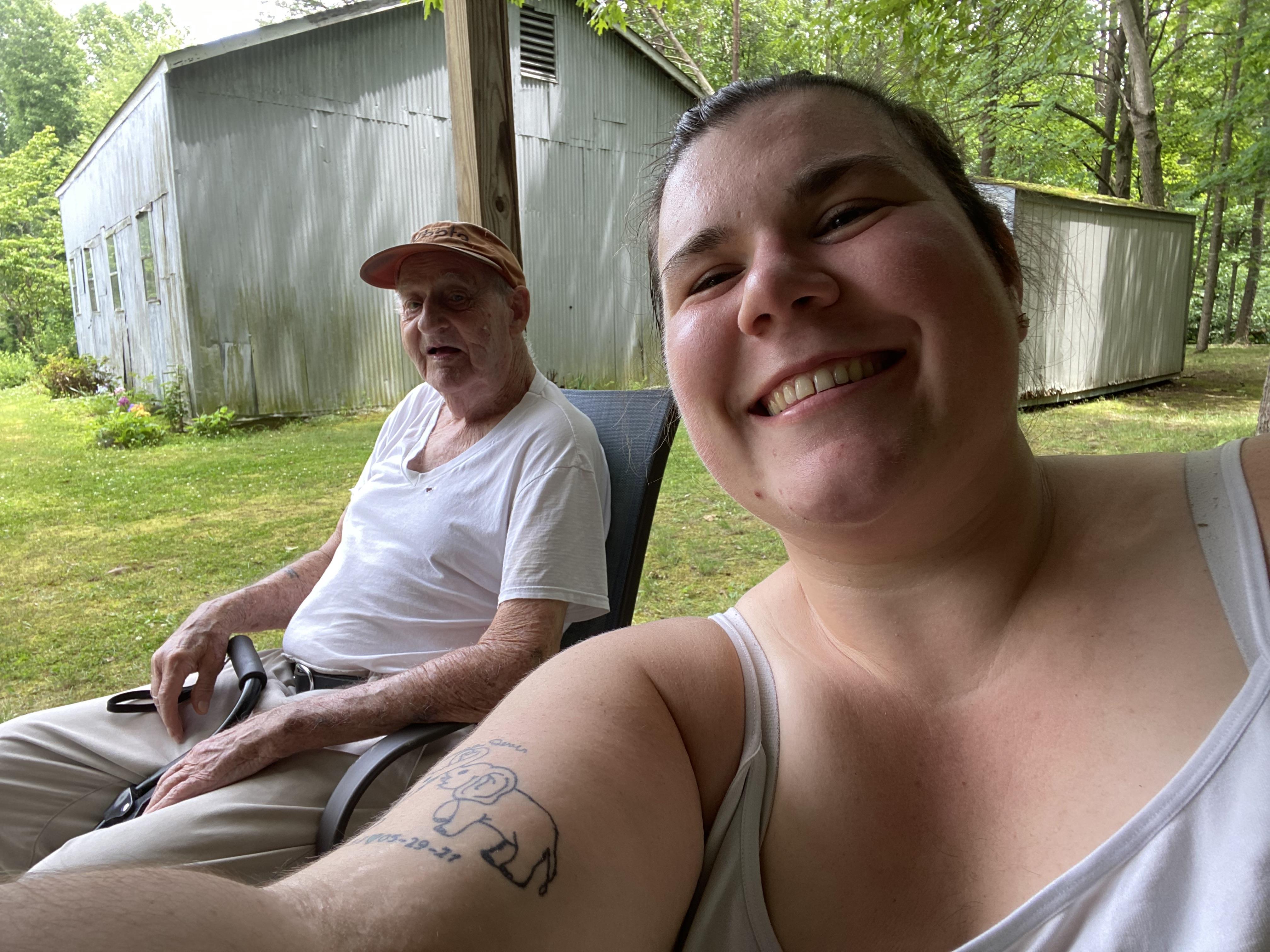 A woman taking a selfie with an old man