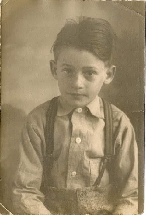A young boy with suspenders