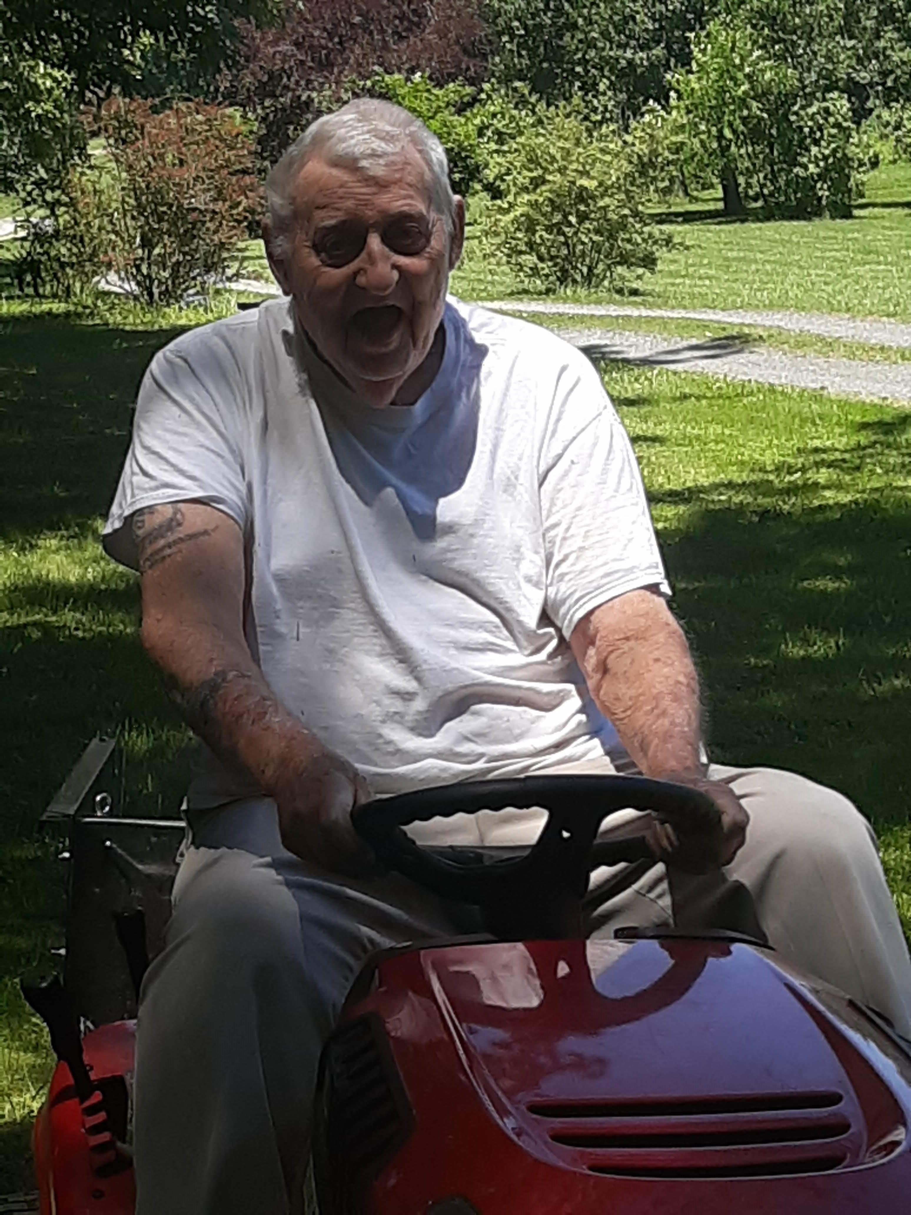 A man driving a lawnmower