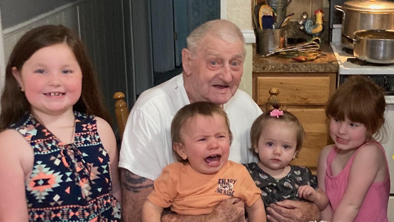 A man holding a baby and crying