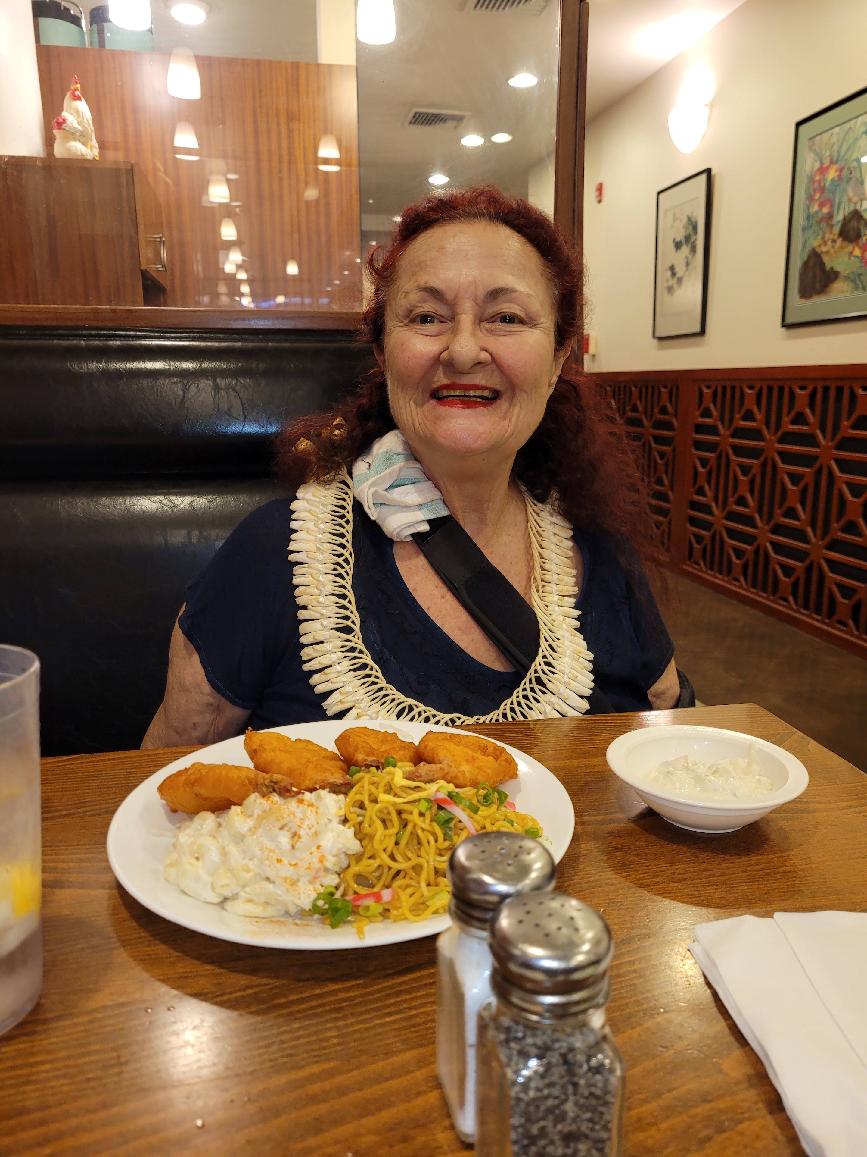 A woman sitting at a table with a plate of food