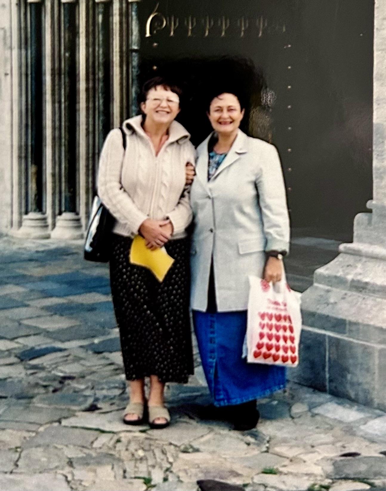 Two women standing together smiling