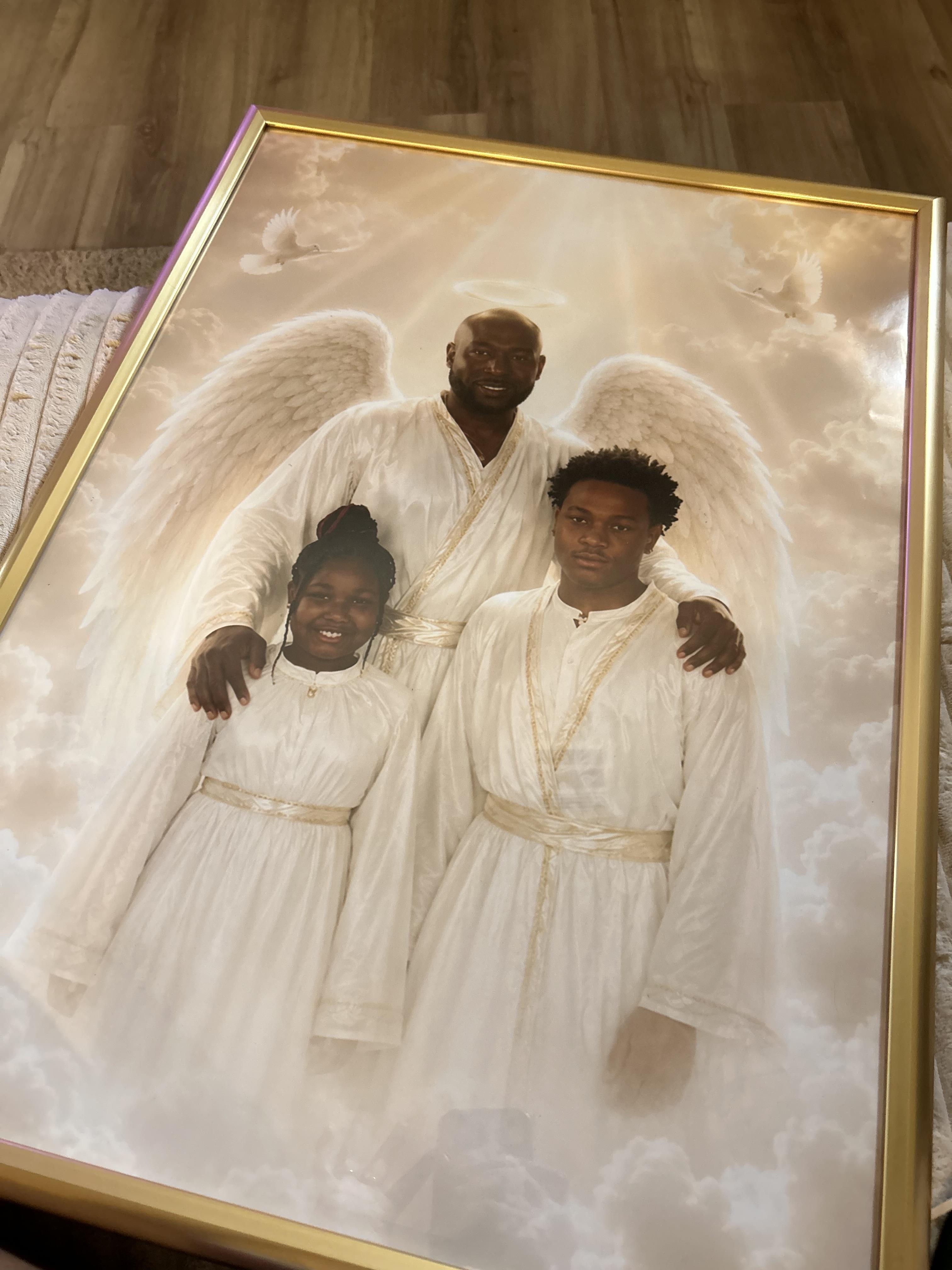 A man and woman in white robes with wings on shoulders