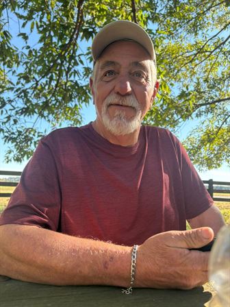A man wearing a hat and a red shirt