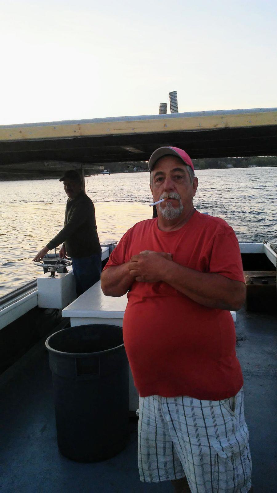 A man in a red shirt on a boat