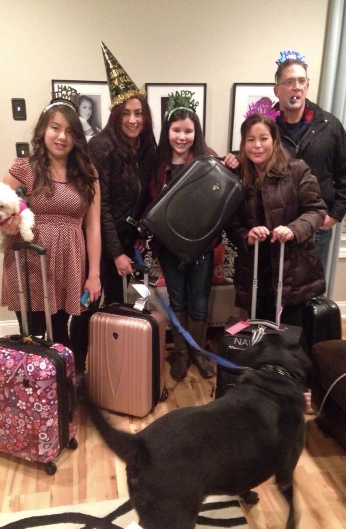 A group of people standing together with luggage