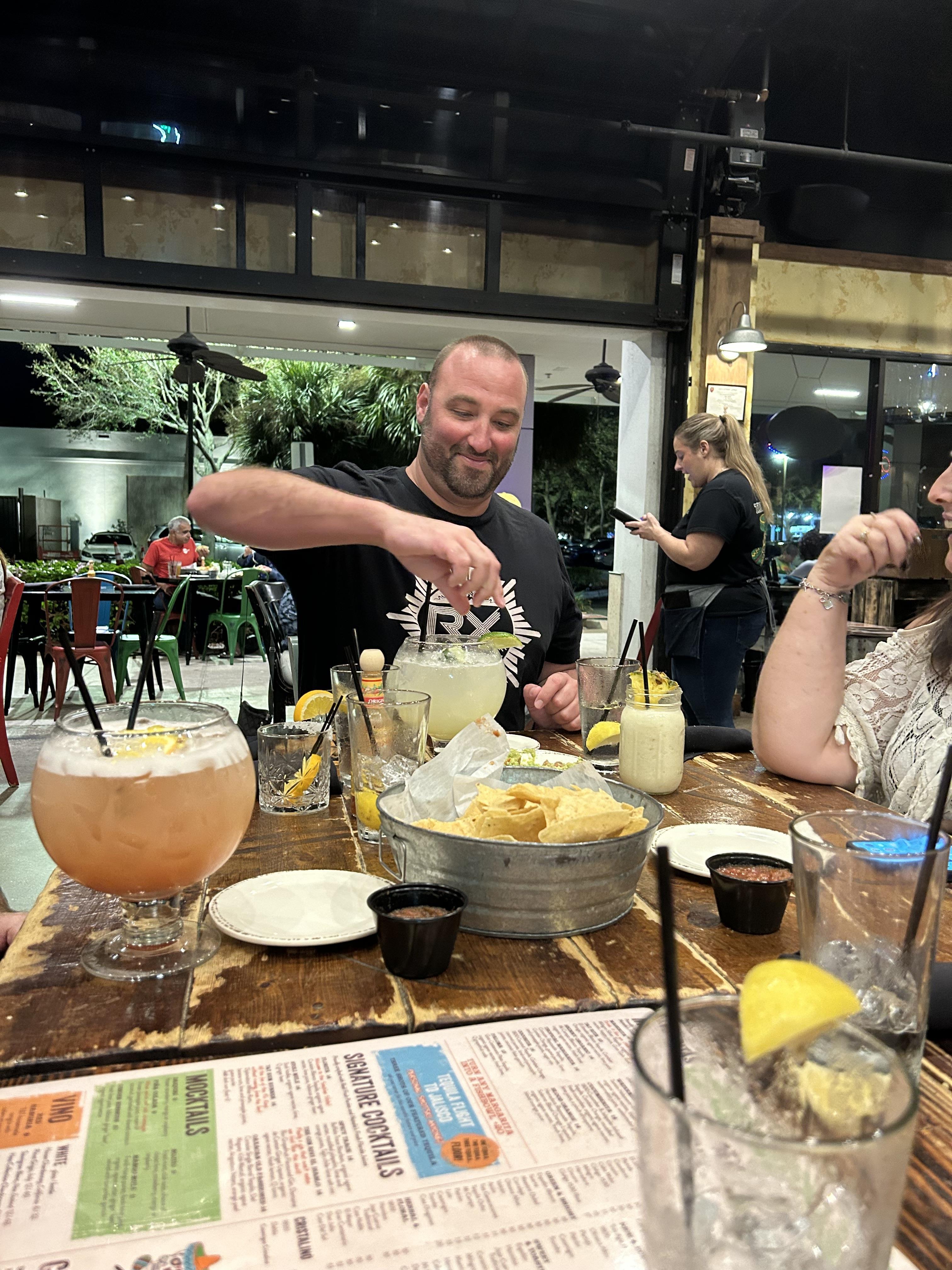 A man pouring straw into a bowl of drink