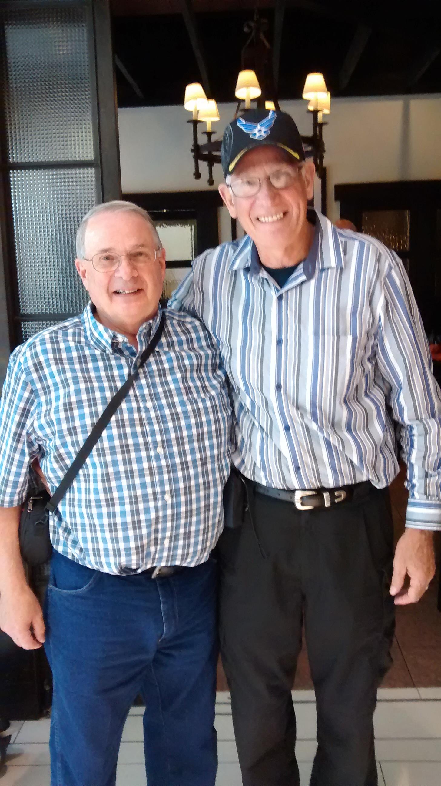 Two men standing together smiling