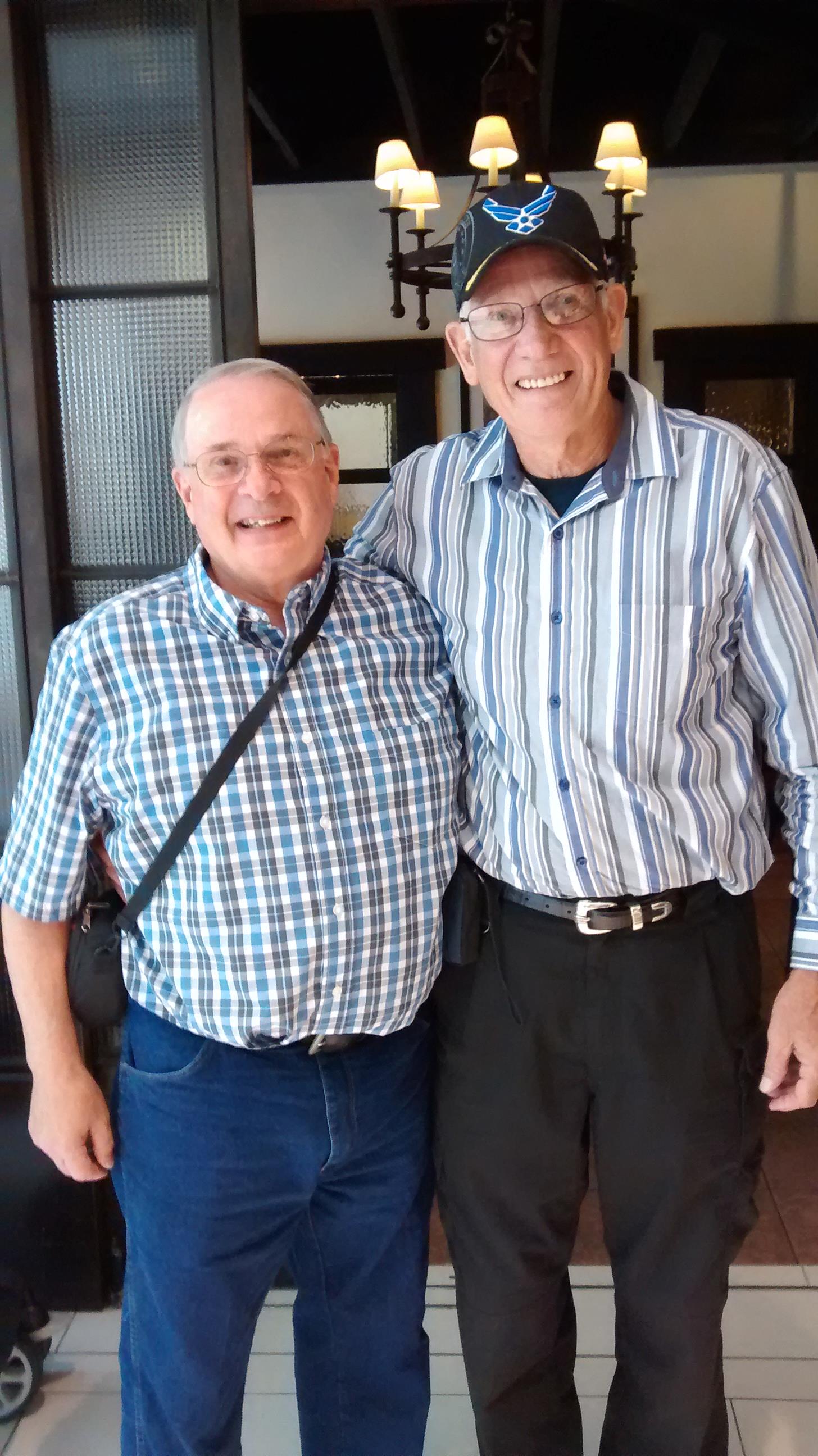 Two men standing together smiling