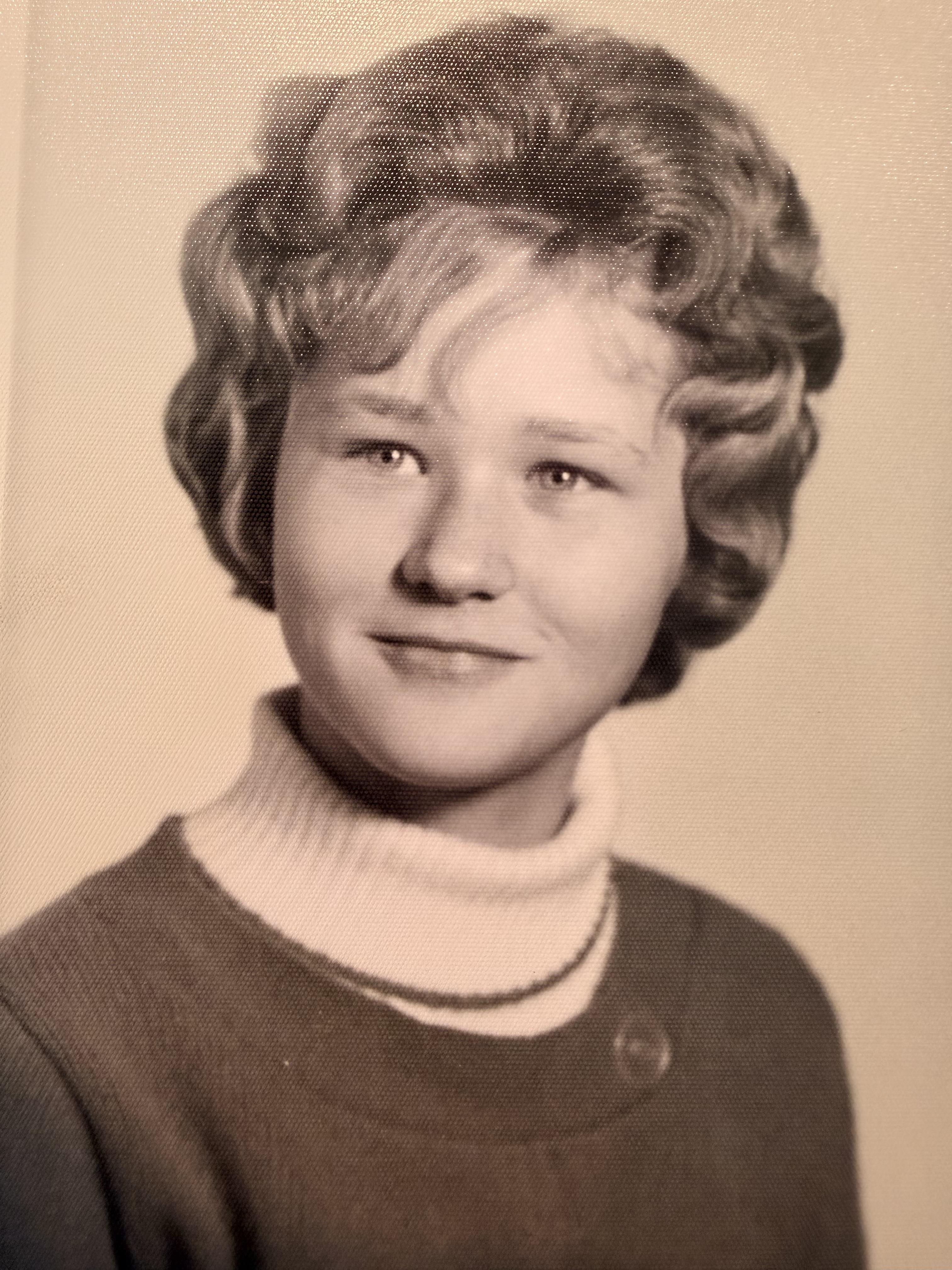 A woman with short hair wearing a sweater