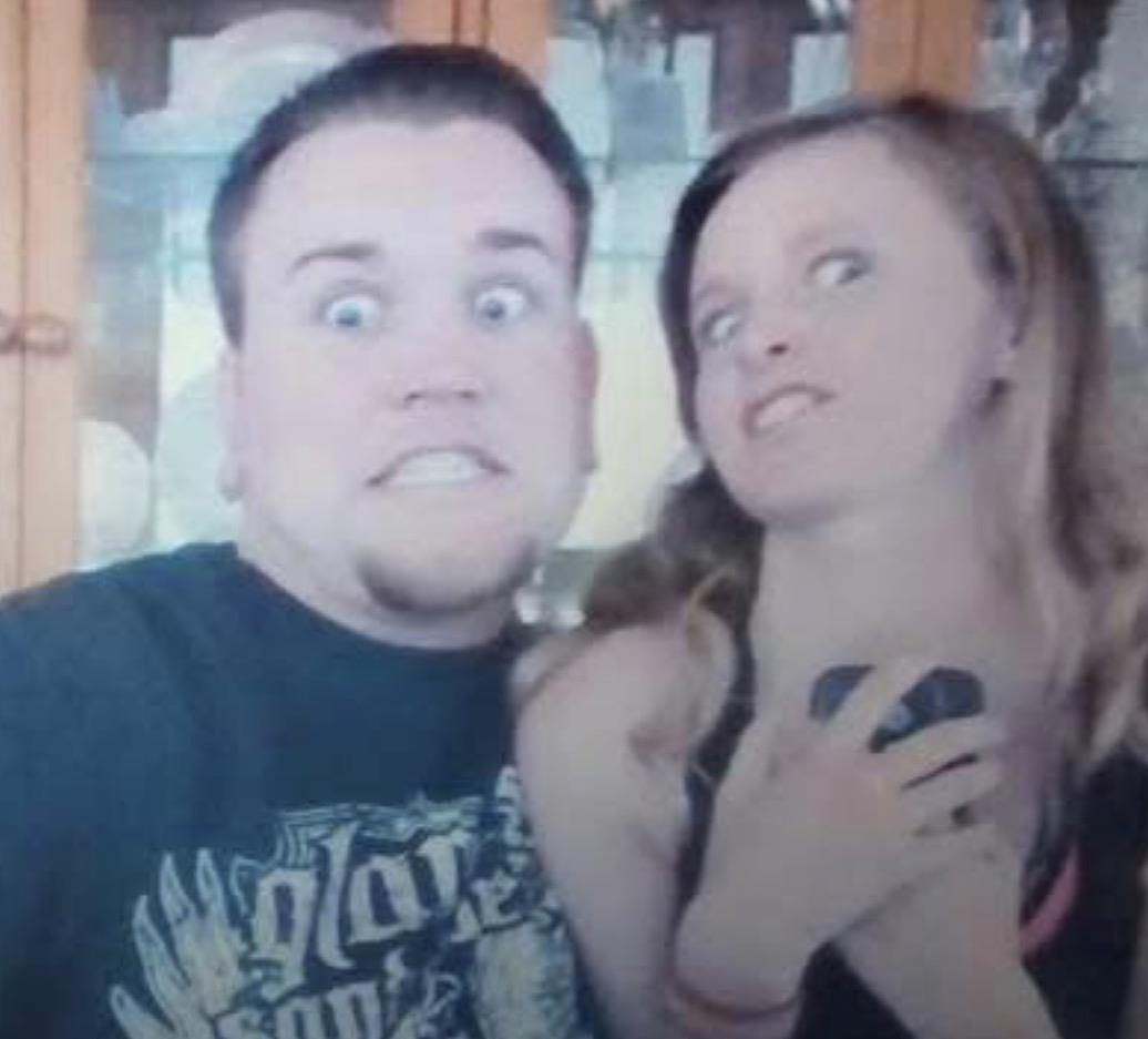A man and woman posing for a picture