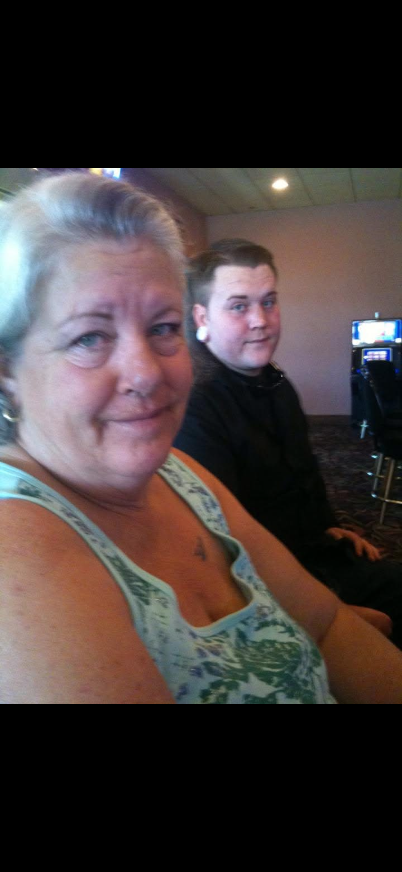 A woman and a boy sitting in a room