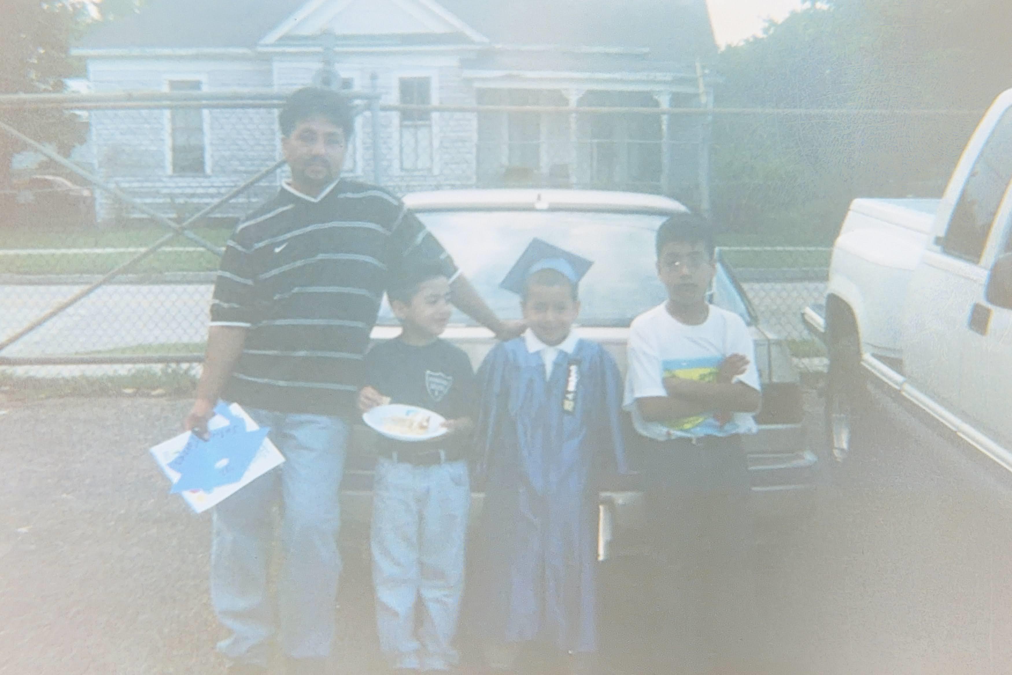 A group of people standing in front of a car