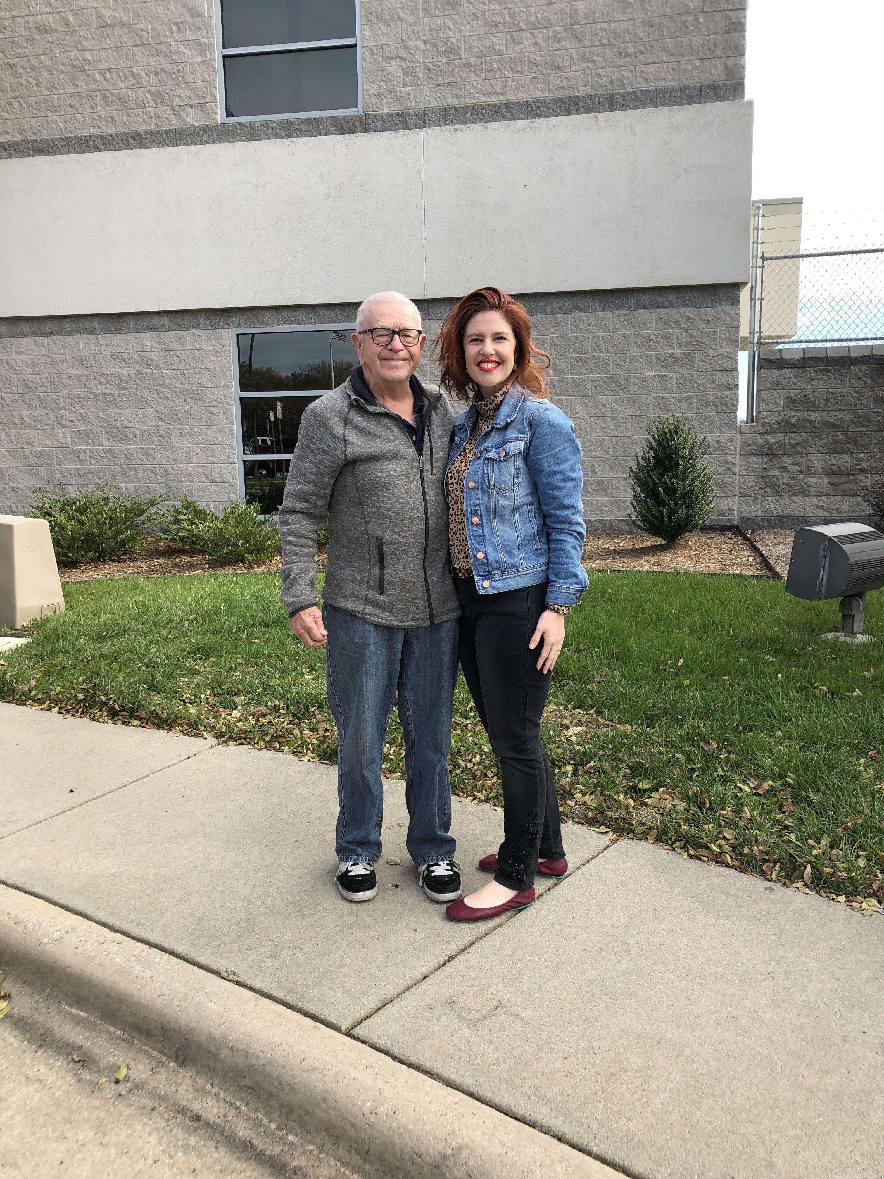 A man and woman standing on a sidewalk