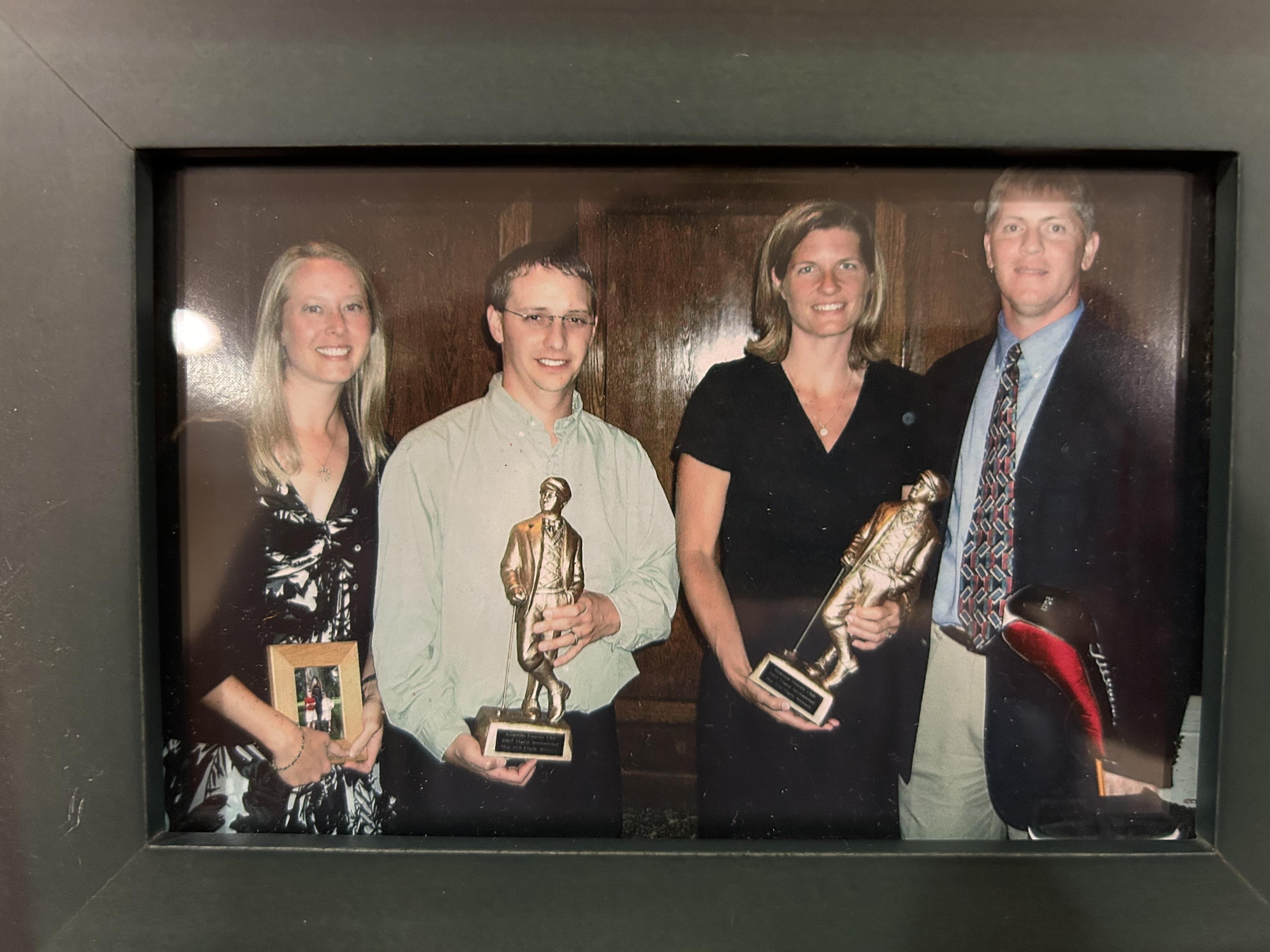 A group of people holding trophies