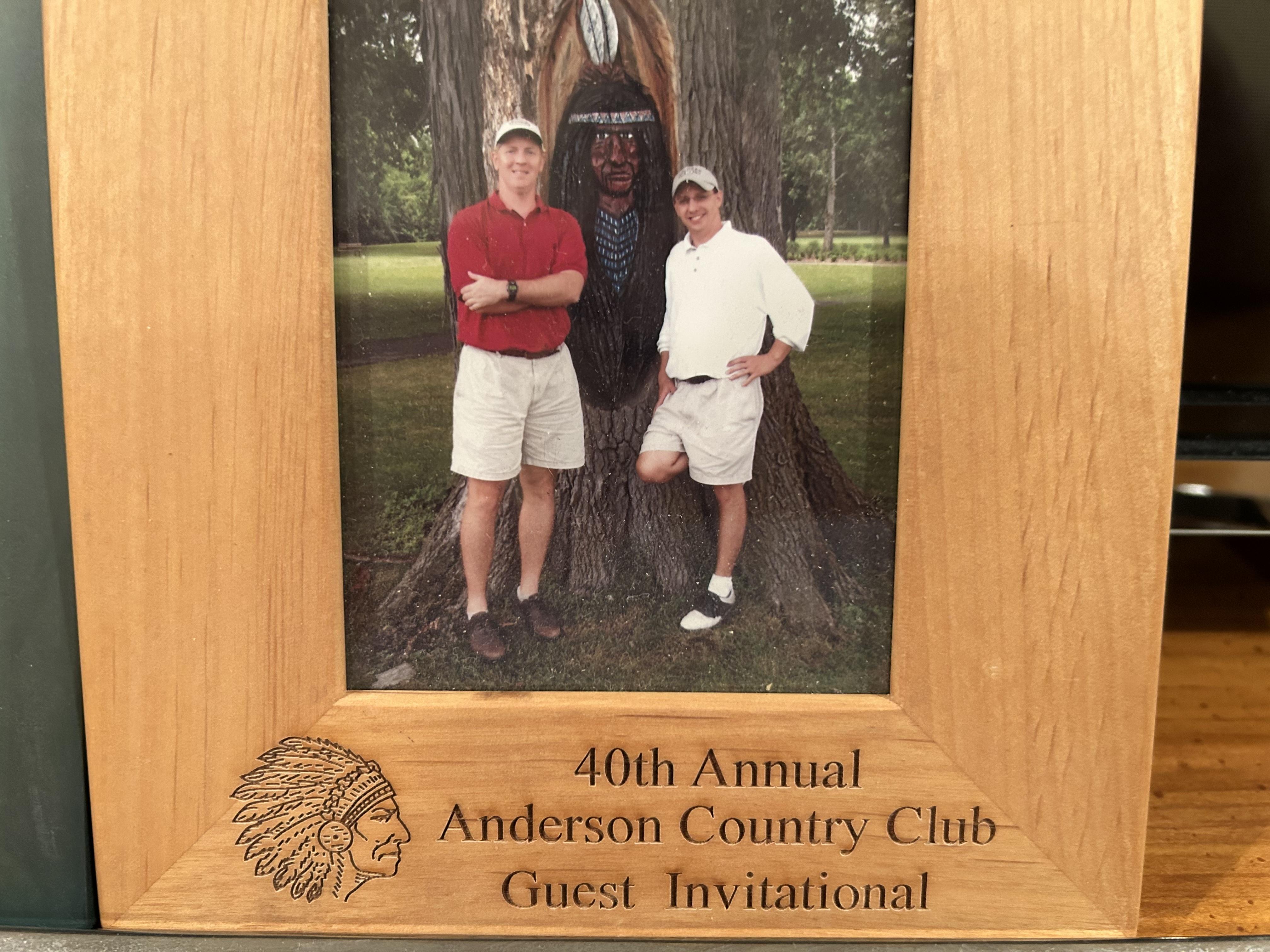 A picture of two men in a wood frame