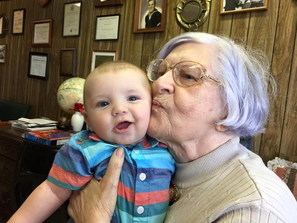 An old woman holding a baby
