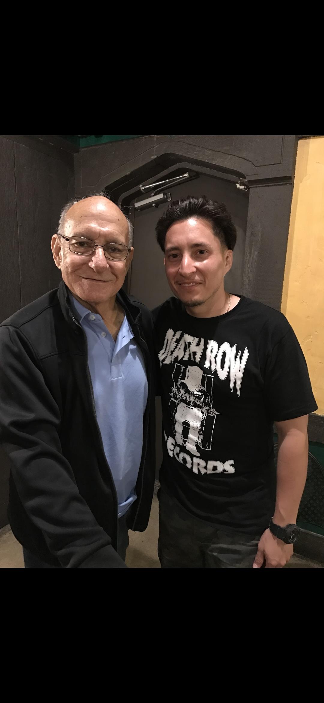 Two men standing together smiling