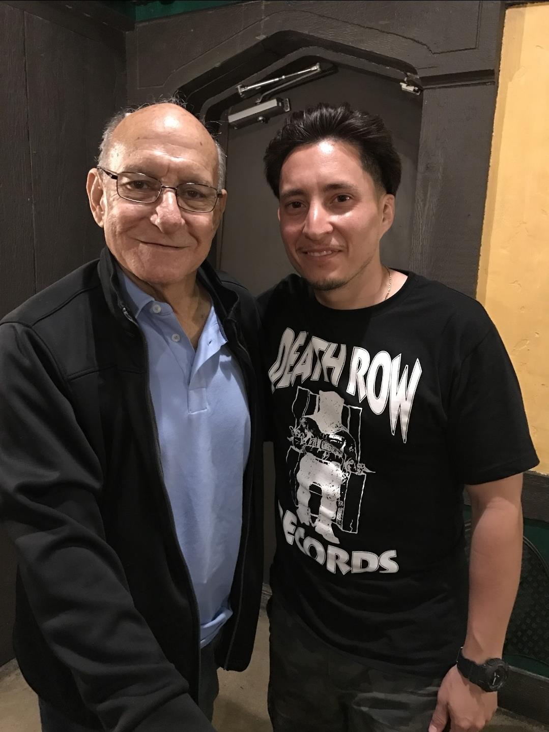 Two men standing together smiling