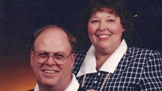 A man and woman smiling