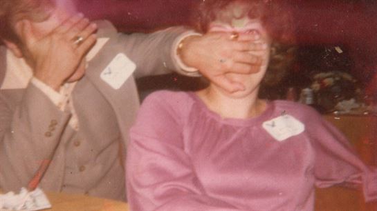 A woman covering her eyes with her hands