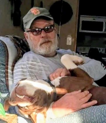 A man holding a dog