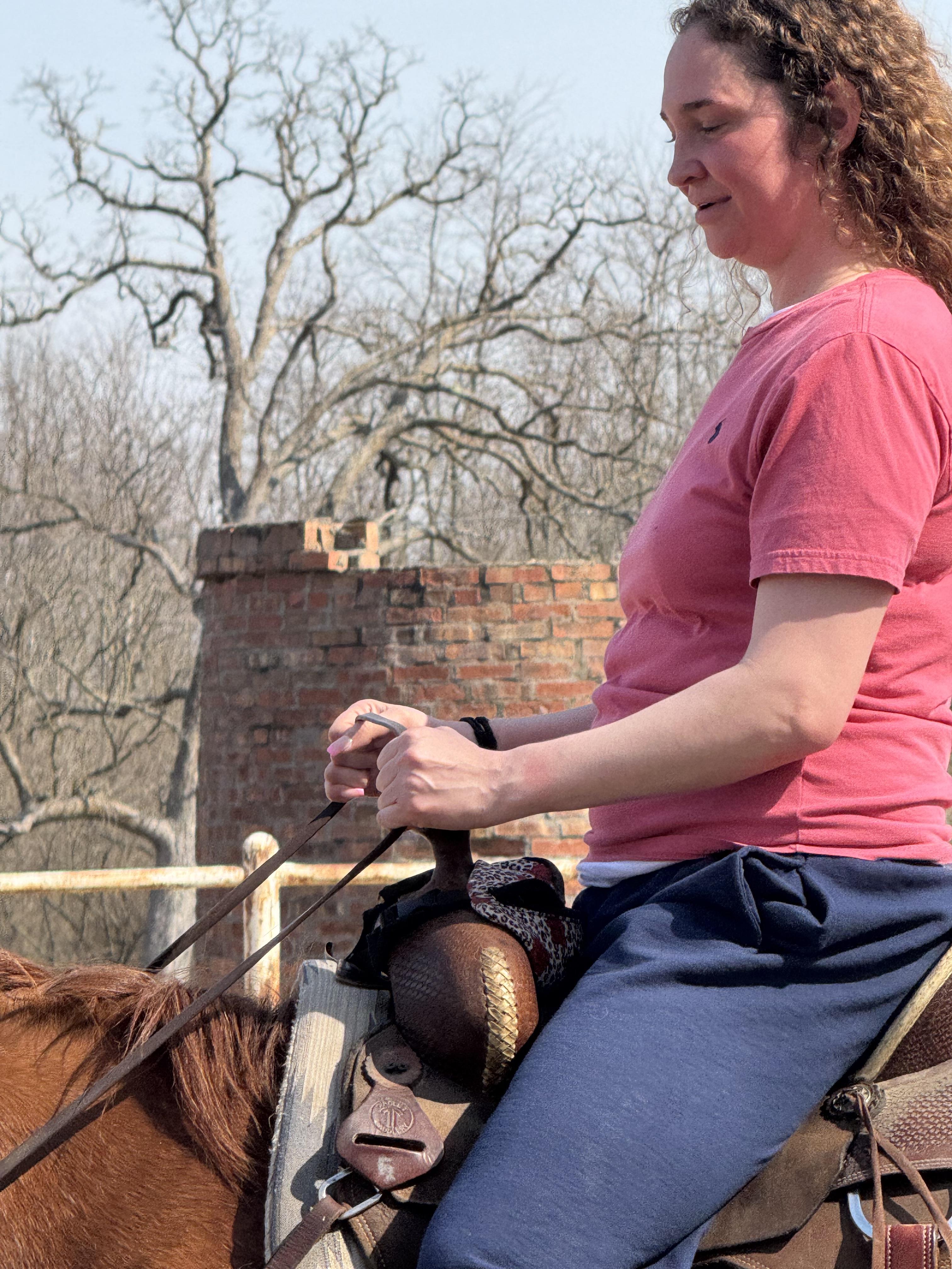 A woman riding a horse