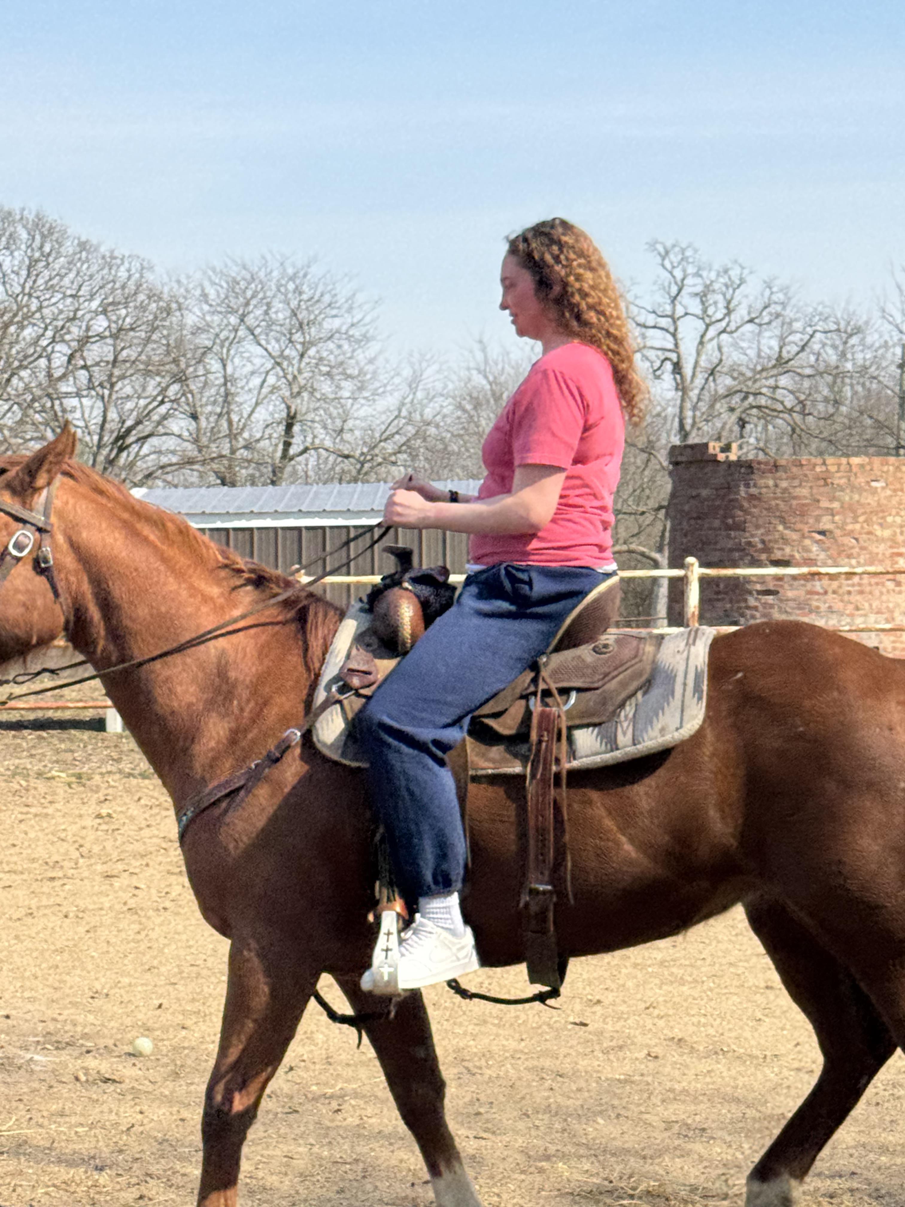 A woman riding a horse