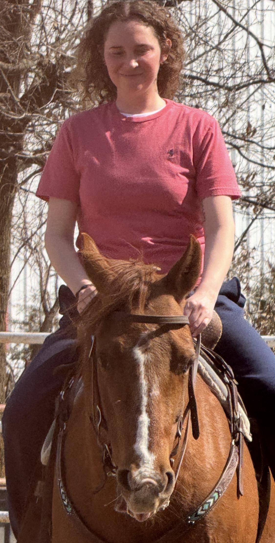 A woman riding a horse